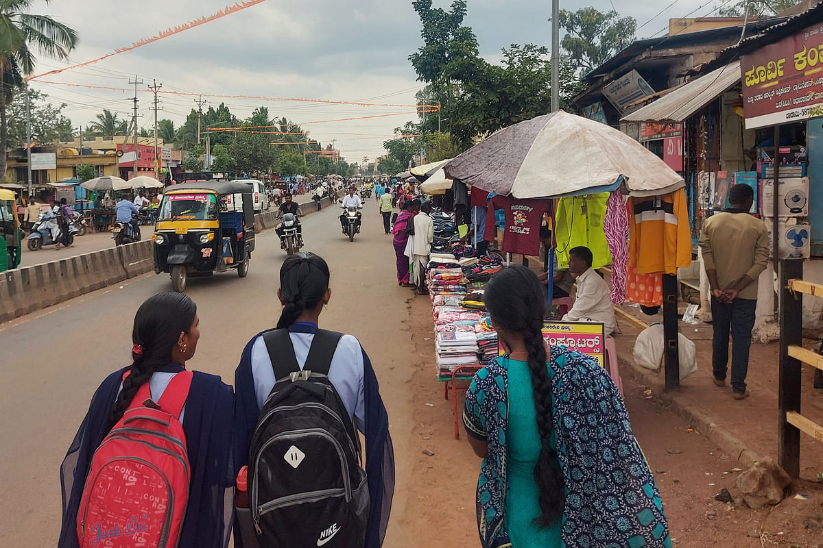 ಬಾದಾಮಿಯ ಪಾದಚಾರಿ ರಸ್ತೆಯಲ್ಲಿ ಗೂಡಂಗಡಿಗಳ ಮಧ್ಯೆಯೇ ಪಾದಚಾರಿಗಳು ಹೋಗುತ್ತಿರುವುದು