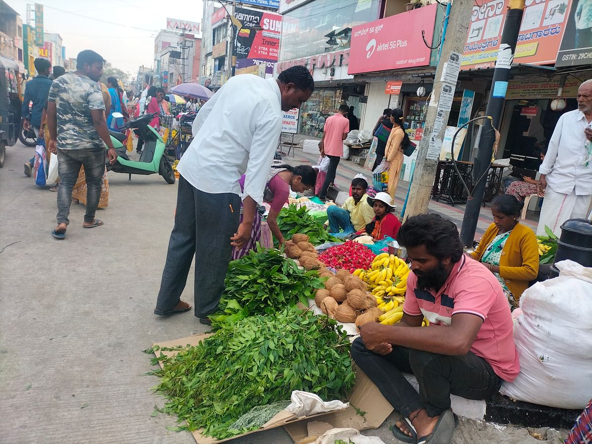 ಹಾಸನದ ಮಾರುಕಟ್ಟೆಯಲ್ಲಿ ಮಾವು ಬೇವಿನ ಎಲೆಗಳನ್ನು ಖರೀದಿಸುತ್ತಿರುವ ಜನರು.