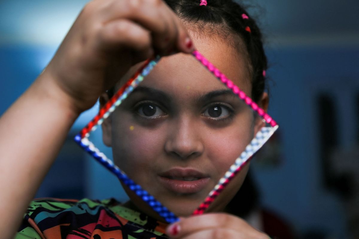 A child resident of Cairo's Zabaleen known as "Garbage City" and member of charity Mesaha, known as "Space" in Arabic, shows a creation made with materials collected from rubbish to recycle, in Manshiyat Nasser, Cairo, Egypt March 17, 2023. REUTERS/Hanaa Habib