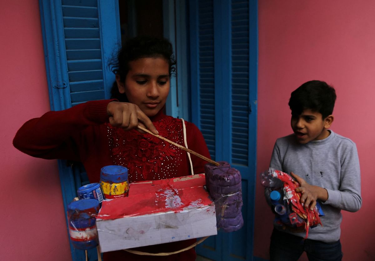 Children residents of Cairo's Zabaleen known as "Garbage City" and member of charity Mesaha, known as "Space" in Arabic, works with materials collected from rubbish to recycle, in Manshiyat Nasser, Cairo, Egypt March 17, 2023. REUTERS/Hanaa Habib