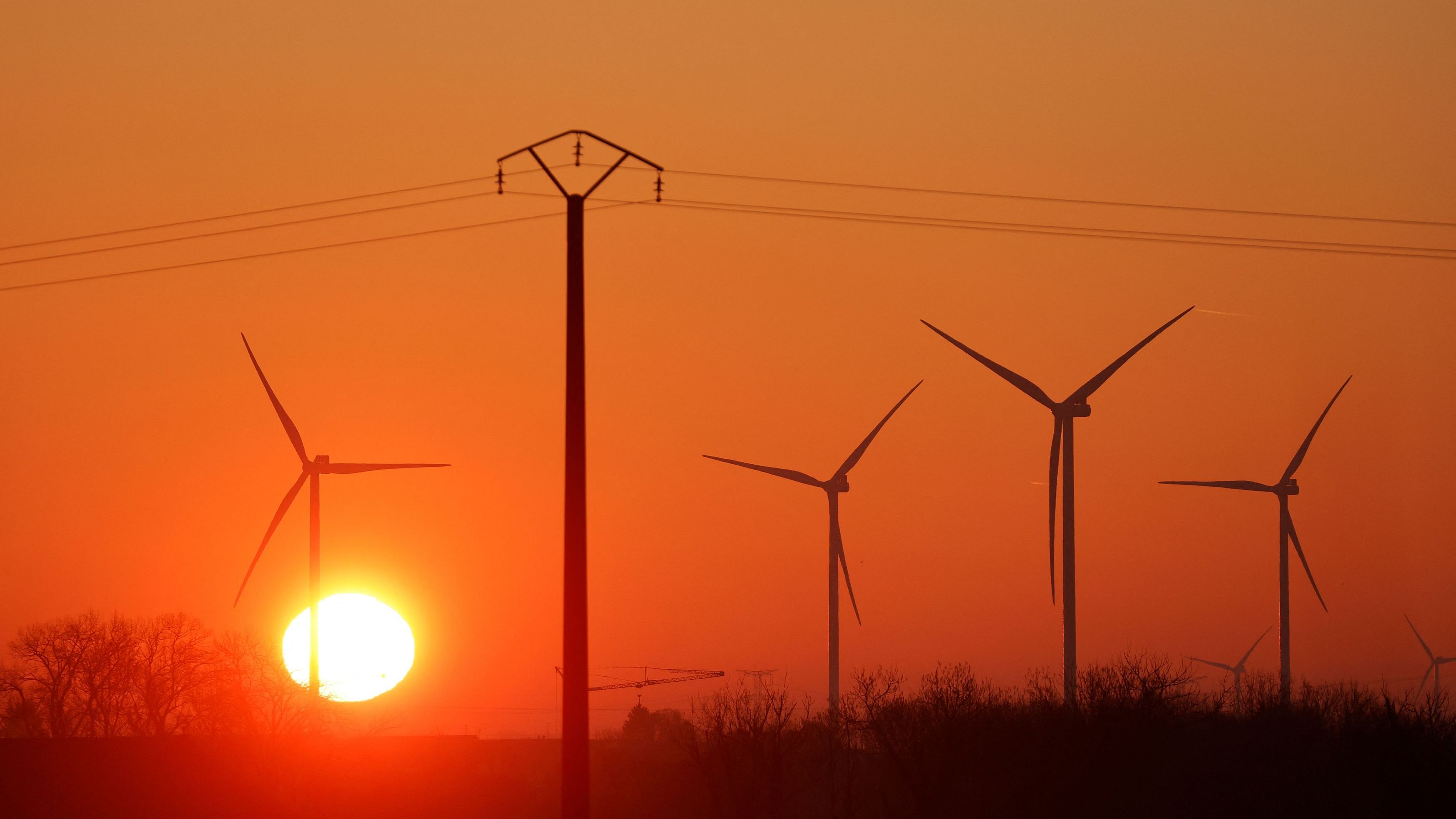 Power-generating windmill turbines are pictured at sunrise at a wind park in Avesnes-le-Sec, France, April 3, 2023. REUTERS/Pascal Rossignol