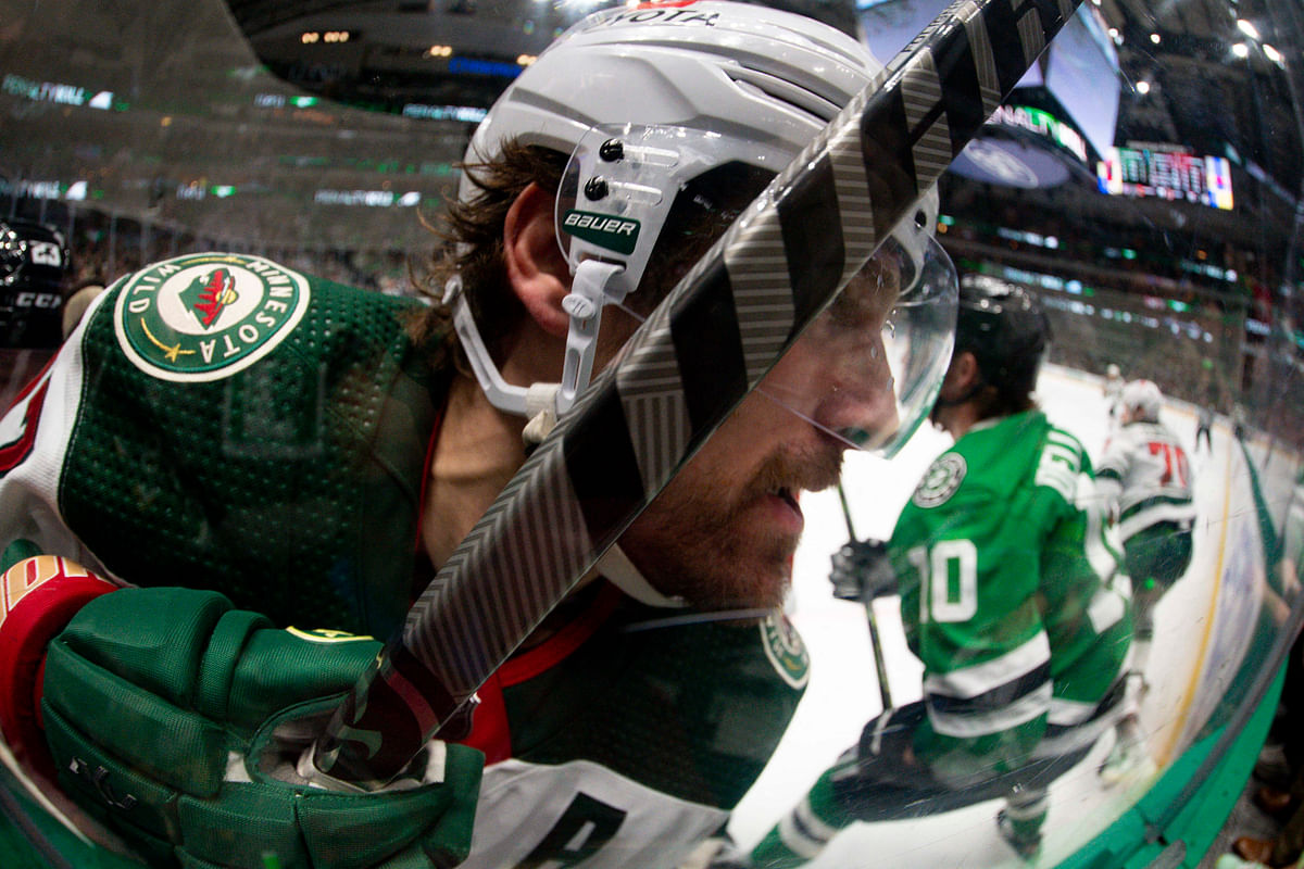 Apr 19, 2023; Dallas, Texas, USA; Minnesota Wild left wing Marcus Foligno  is checked into the glass during the third period against the Dallas Stars in game two of the first round of the 2023 Stanley Cup Playoffs at American Airlines Center. Mandatory Credit: Jerome Miron-USA TODAY Sports