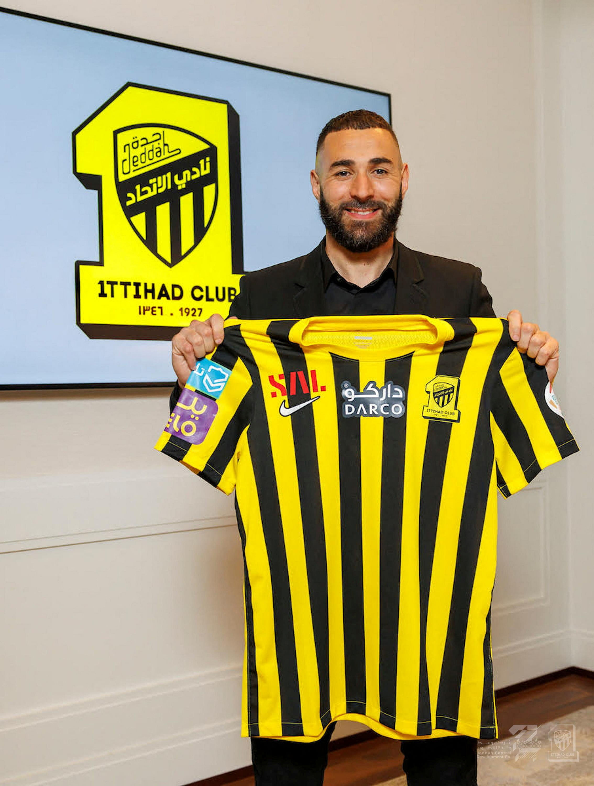 Karim Benzema poses with the jersey of Saudi Arabian soccer team Al-Ittihad on Tuesday. REUTERS