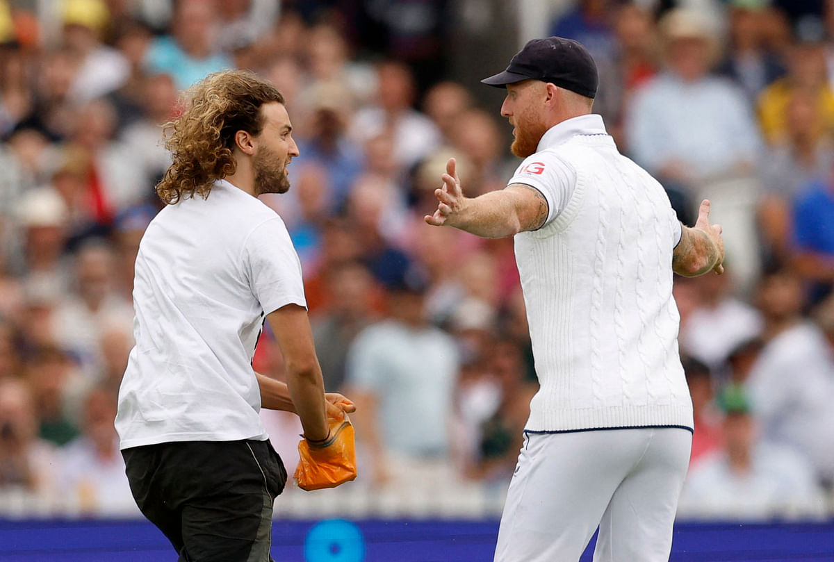 Cricket - Ashes - Second Test - England v Australia - Lord's Cricket Ground, London, Britain - June 28, 2023 England's Ben Stokes tries to stop a just stop oil protester Action Images via Reuters/Peter Cziborra