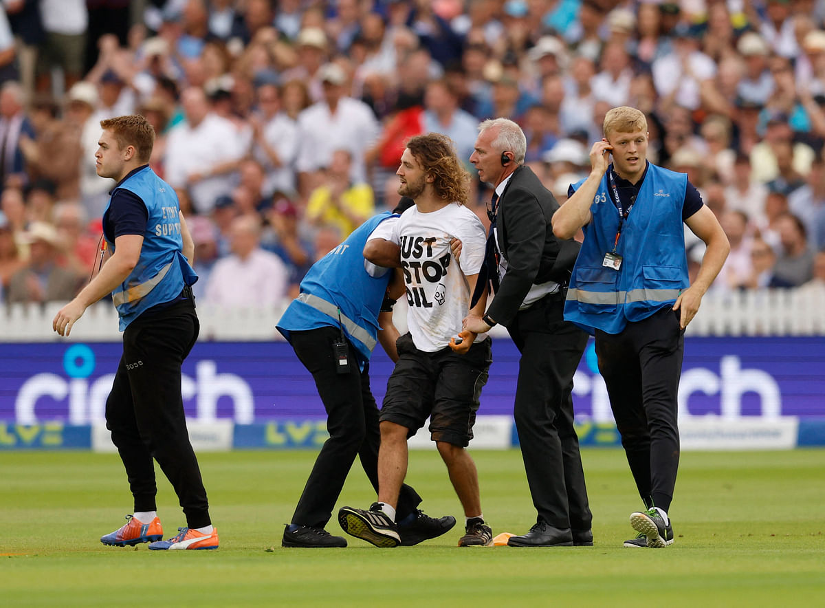 Cricket - Ashes - Second Test - England v Australia - Lord's Cricket Ground, London, Britain - June 28, 2023 Stewards escort a just stop oil protester off the field Action Images via Reuters/Peter Cziborra