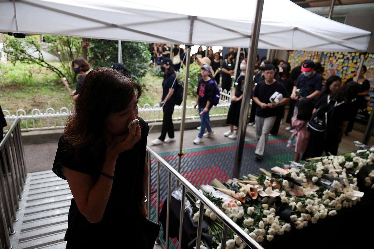 A woman reacts after mourning in front of a classroom where a young teacher was found dead in July in an apparent suicide, at an elementary school in Seoul, South Korea, September 4, 2023. REUTERS/Kim Hong-Ji