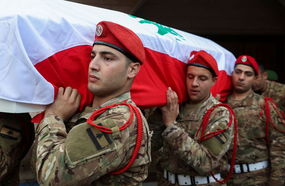 Lebanese army soldiers carry the coffin of army Sergeant Abdul Karim al-Moqdad, who was killed in what the Lebanese army said in their statement was an Israeli shelling on Tuesday near a village in south Lebanon, at Chmistar, Lebanon December 6, 2023. REUTERS/Mohamed Azakir