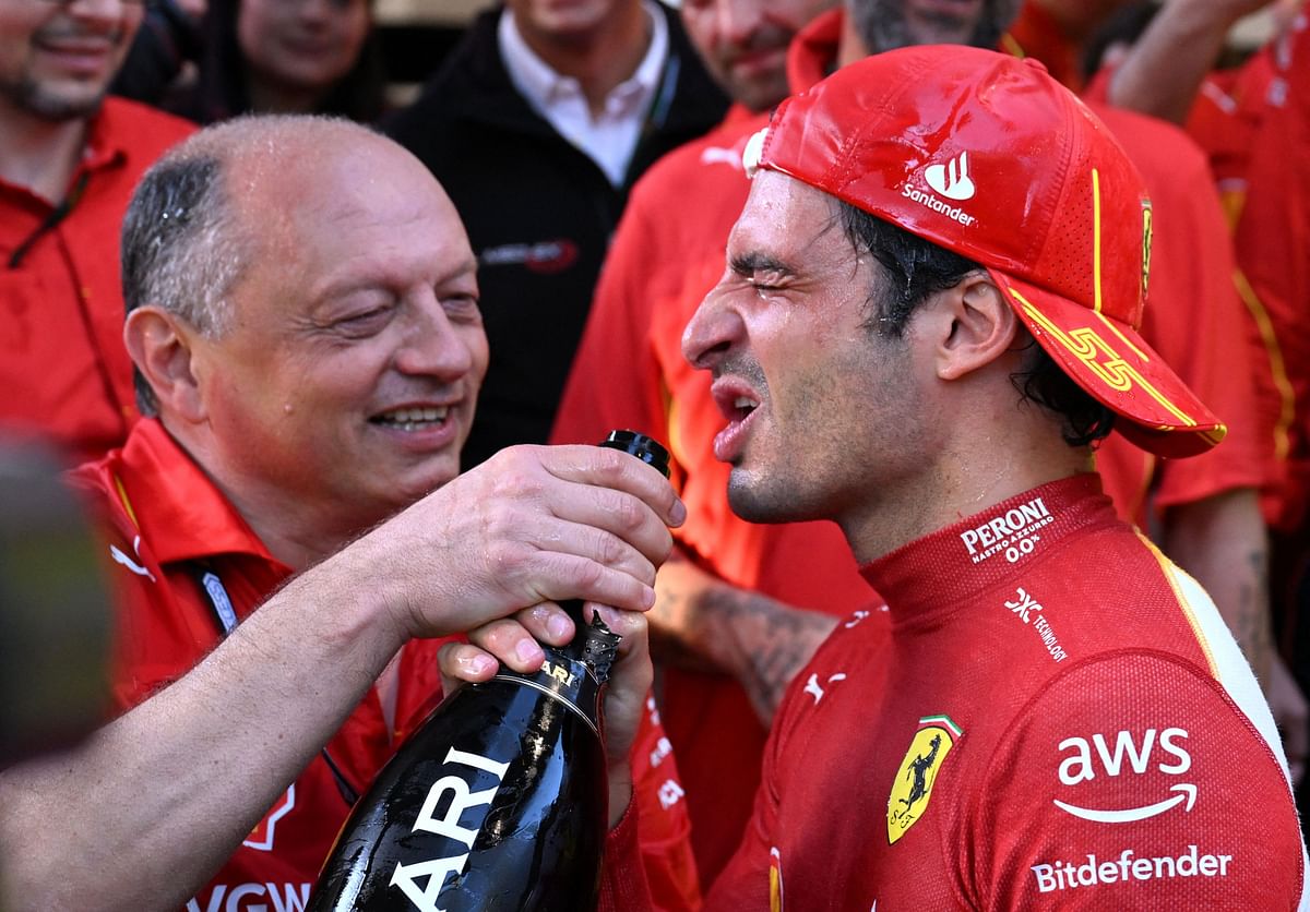 Formula One F1 - Australian Grand Prix - Melbourne Grand Prix Circuit, Melbourne, Australia - March 24, 2024 Ferrari's Carlos Sainz Jr. celebrates after winning the Australian Grand Prix along with team principal Frederic Vasseur REUTERS/Jaimi Joy