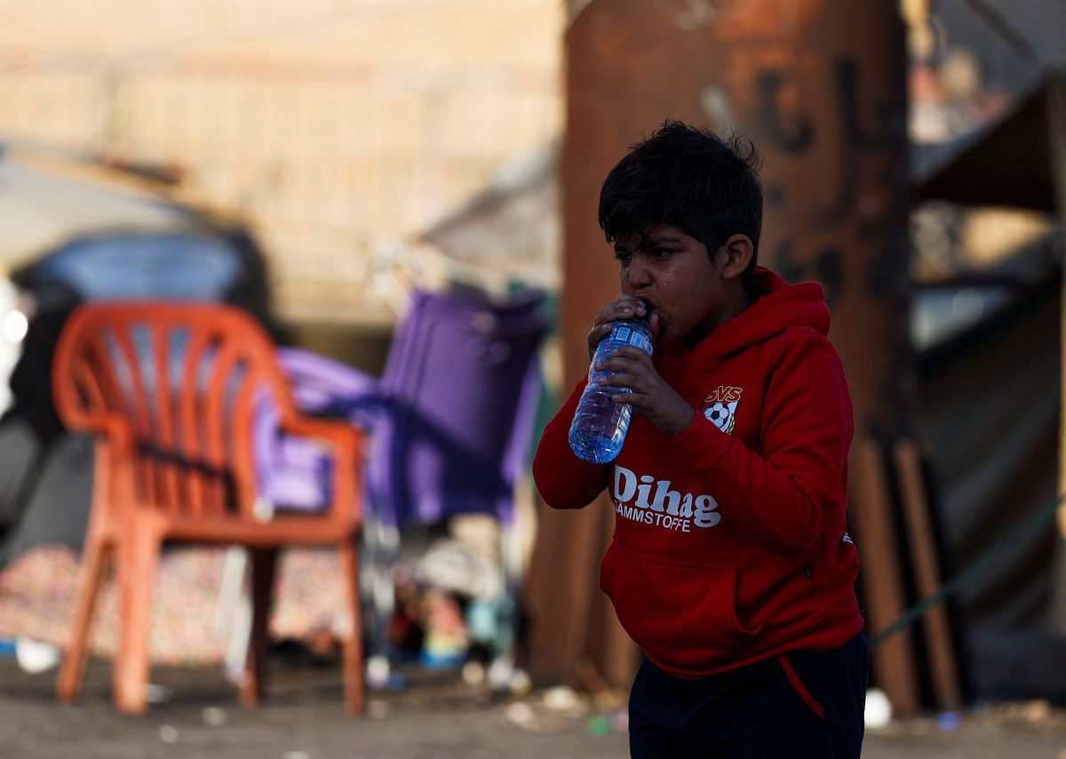 <div class="paragraphs"><p>A displaced boy drinks water on the street at Beirut's central Martyrs' Square.</p></div>