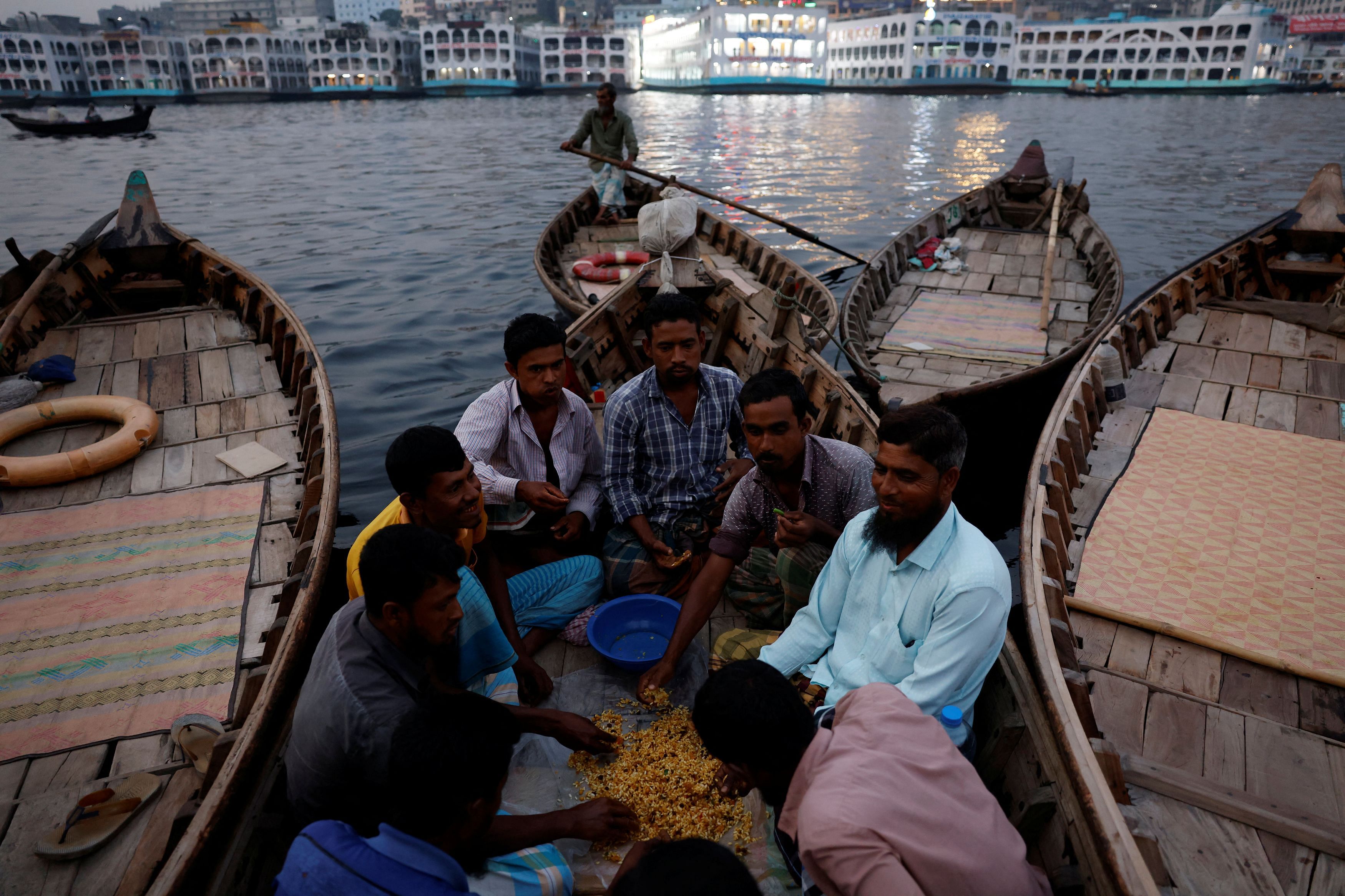 <div class="paragraphs"><p>Mohammad Jahid , 47, has iftar, the fast-breaking evening meal of Ramadan, on a boat along with other ferrymen, in Dhaka, </p></div>