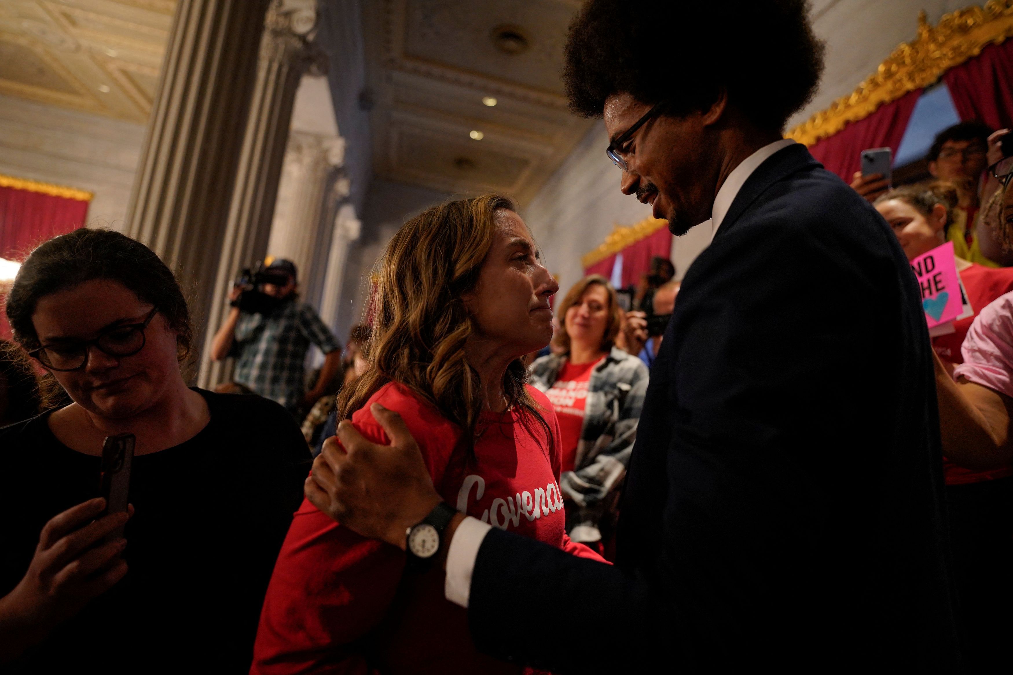 Rep. Justin Pearson speaks to the crying mother of a Covenant School student in the gallery of the Tennessee's House of Representatives on the day it is scheduled to vote to expel three Democratic members for their roles in a gun control demonstration at the statehouse last week, in Nashville, Tennessee, U.S., April 6, 2023. REUTERS/Cheney Orr