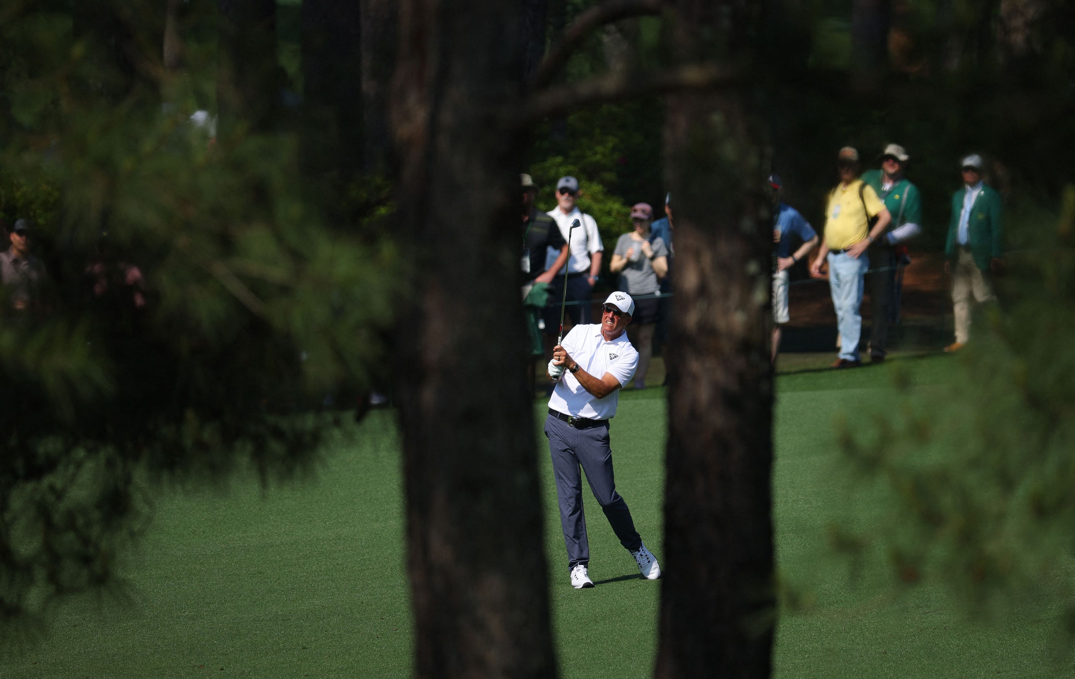 Golf - The Masters - Augusta National Golf Club - Augusta, Georgia, U.S. - April 5, 2023  Phil Mickelson of the U.S. hits his approach on the 7th during a practice round REUTERS/Brian Snyder