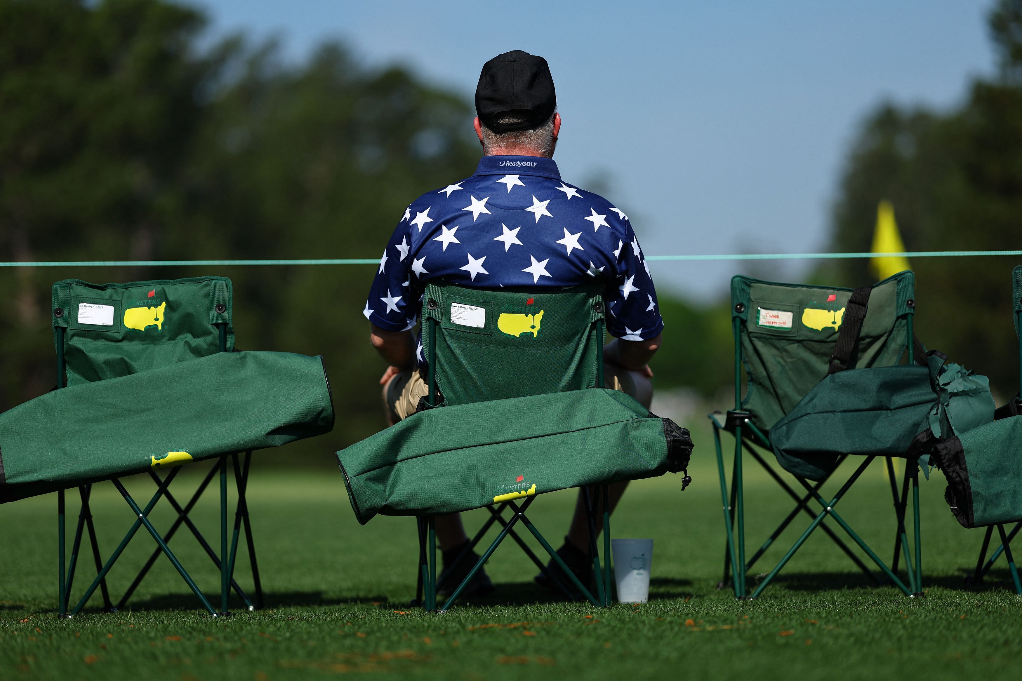 Golf - The Masters - Augusta National Golf Club - Augusta, Georgia, U.S. - April 5, 2023  Patron sits by the 7th green during a practice round REUTERS/Mike Segar