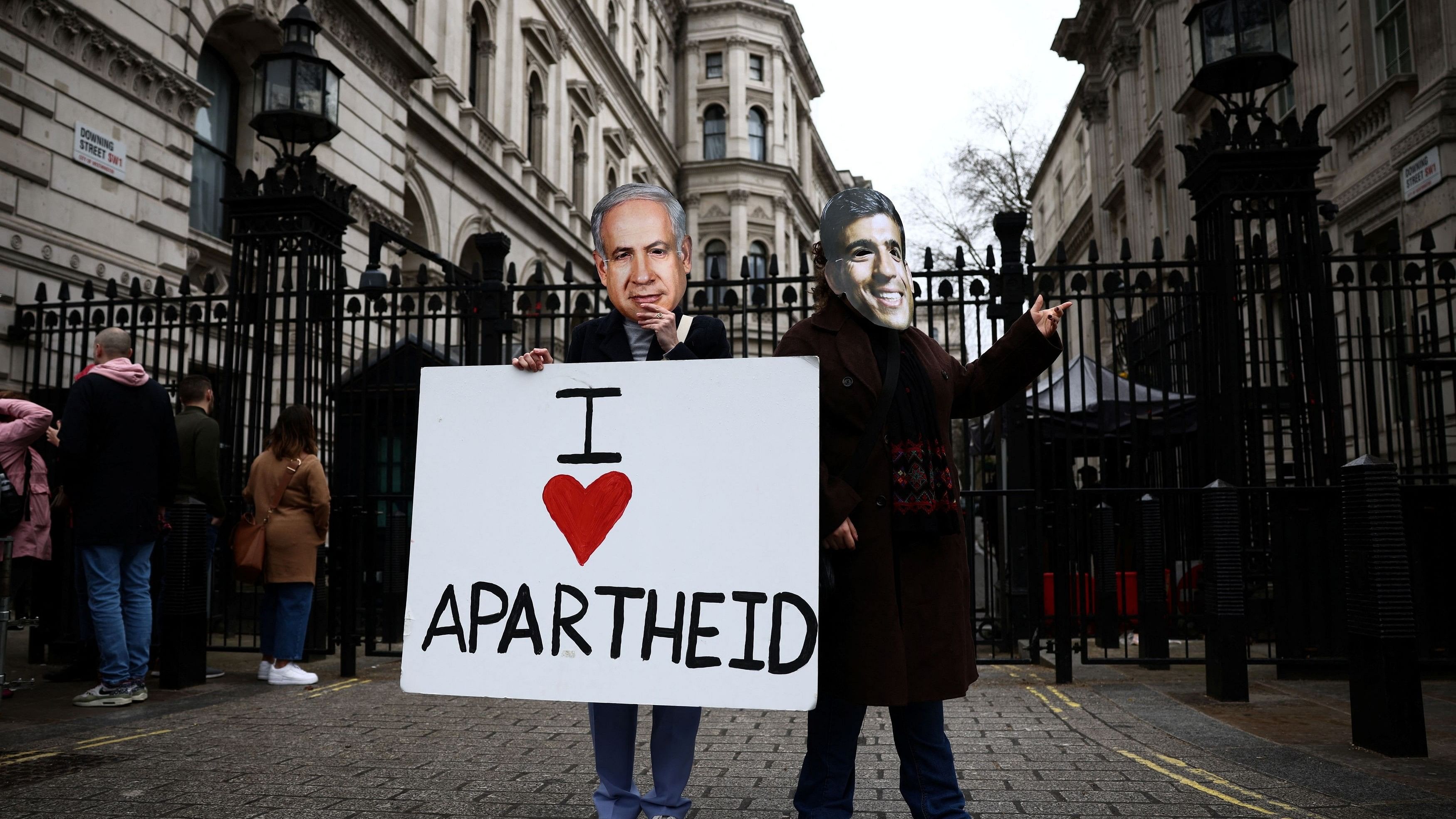 Activists from Amnesty International UK protest outside Downing Street, in London