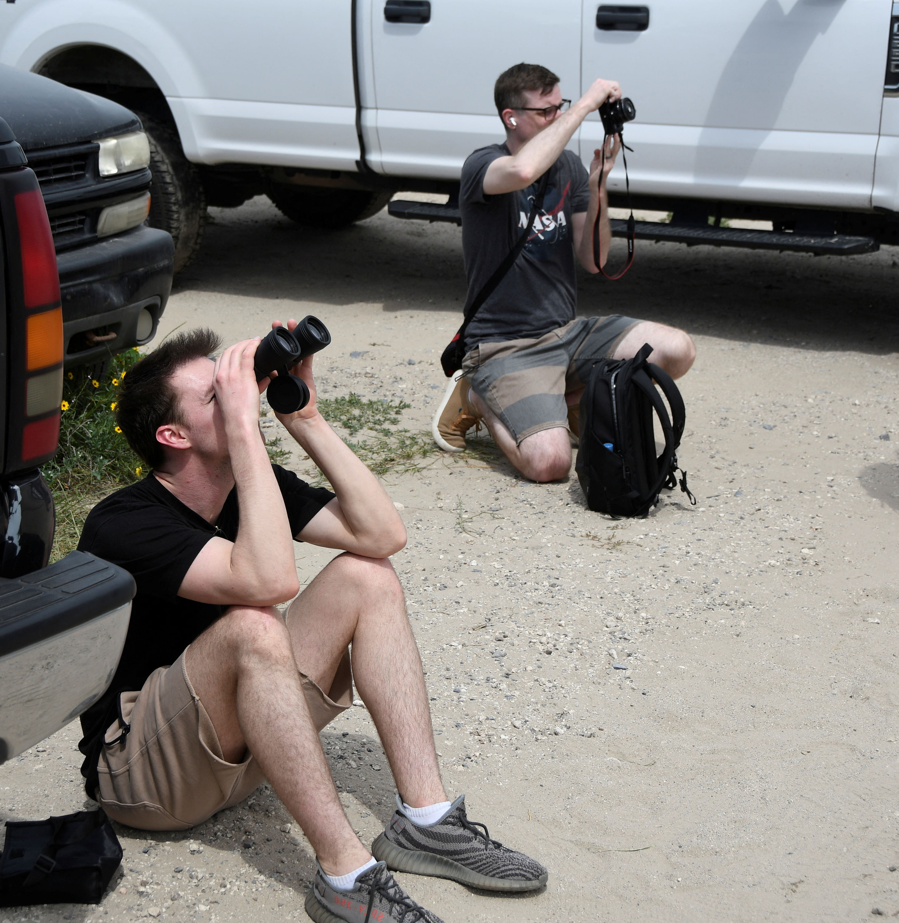 A tourist takes photos of SpaceX's Starship the day before it launches from the Starbase launchpad on an orbital test mission, in Boca Chica, Texas, U.S., April 16, 2023.  REUTERS/Gene Blevins