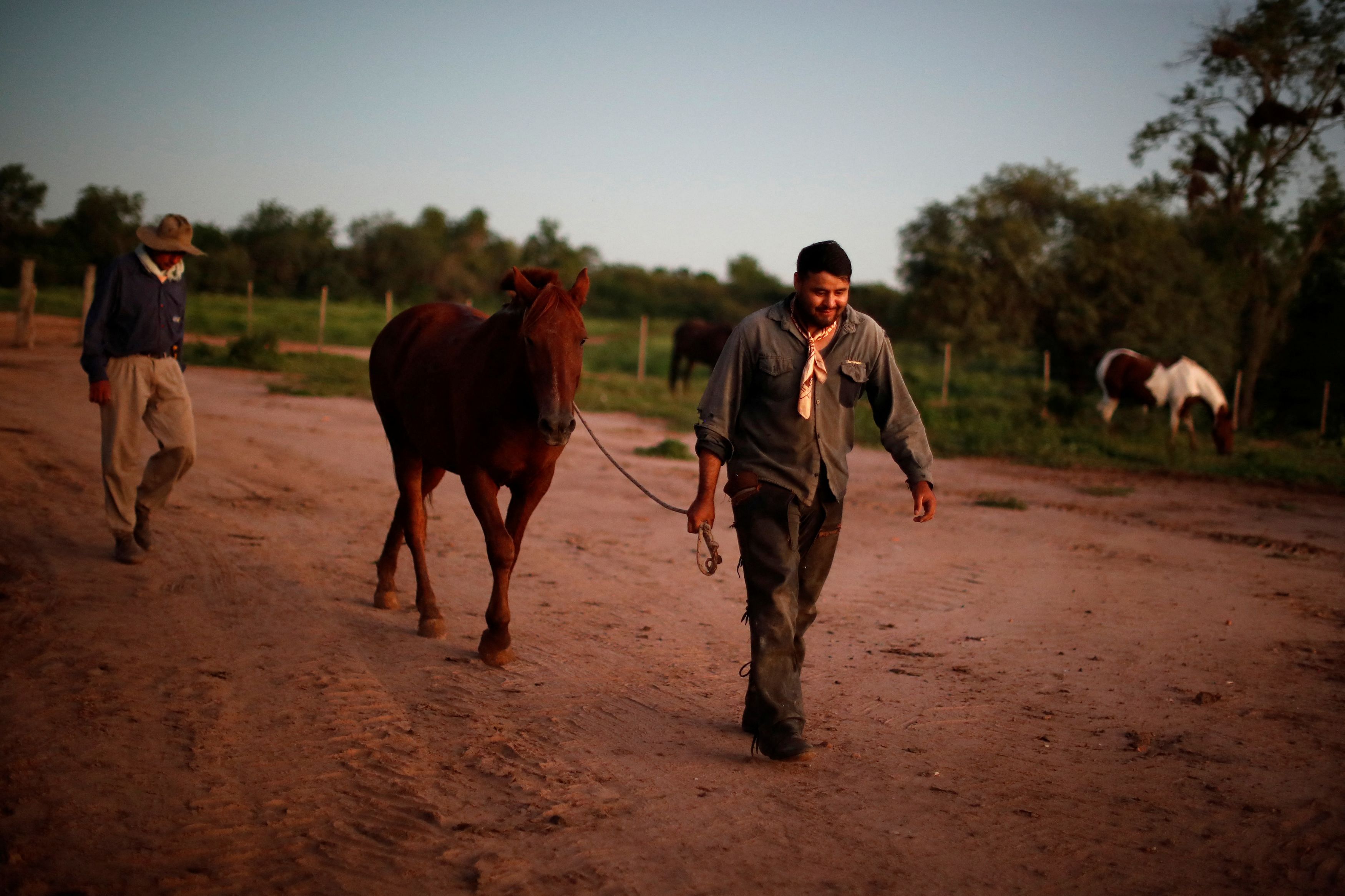 Rural workers end their work day, in Pozo del Tigre, in Formosa, Argentina April 19, 2023. The Gran Chaco is facing growing pressure as large-scale farms producing soy and cattle expand to meet global food demand. REUTERS/Agustin Marcarian     SEARCH "CHACO" FOR THIS STORY. SEARCH "WIDER IMAGE" FOR ALL STORIES.