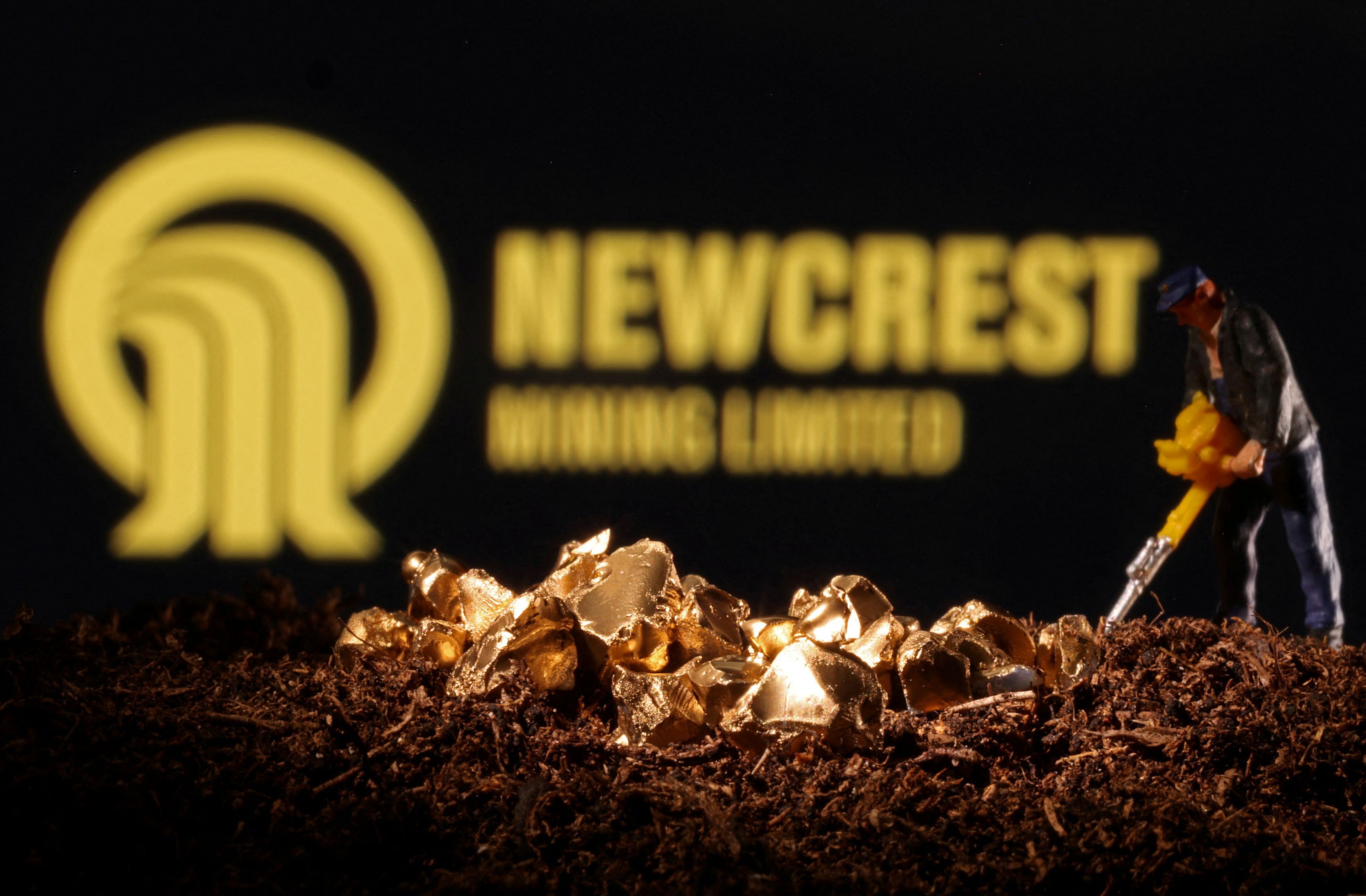 FILE PHOTO: A small toy figure and imitation gold are seen in front of the Newcrest logo in this illustration taken November 19, 2021. REUTERS/Dado Ruvic/Illustration/File Photo