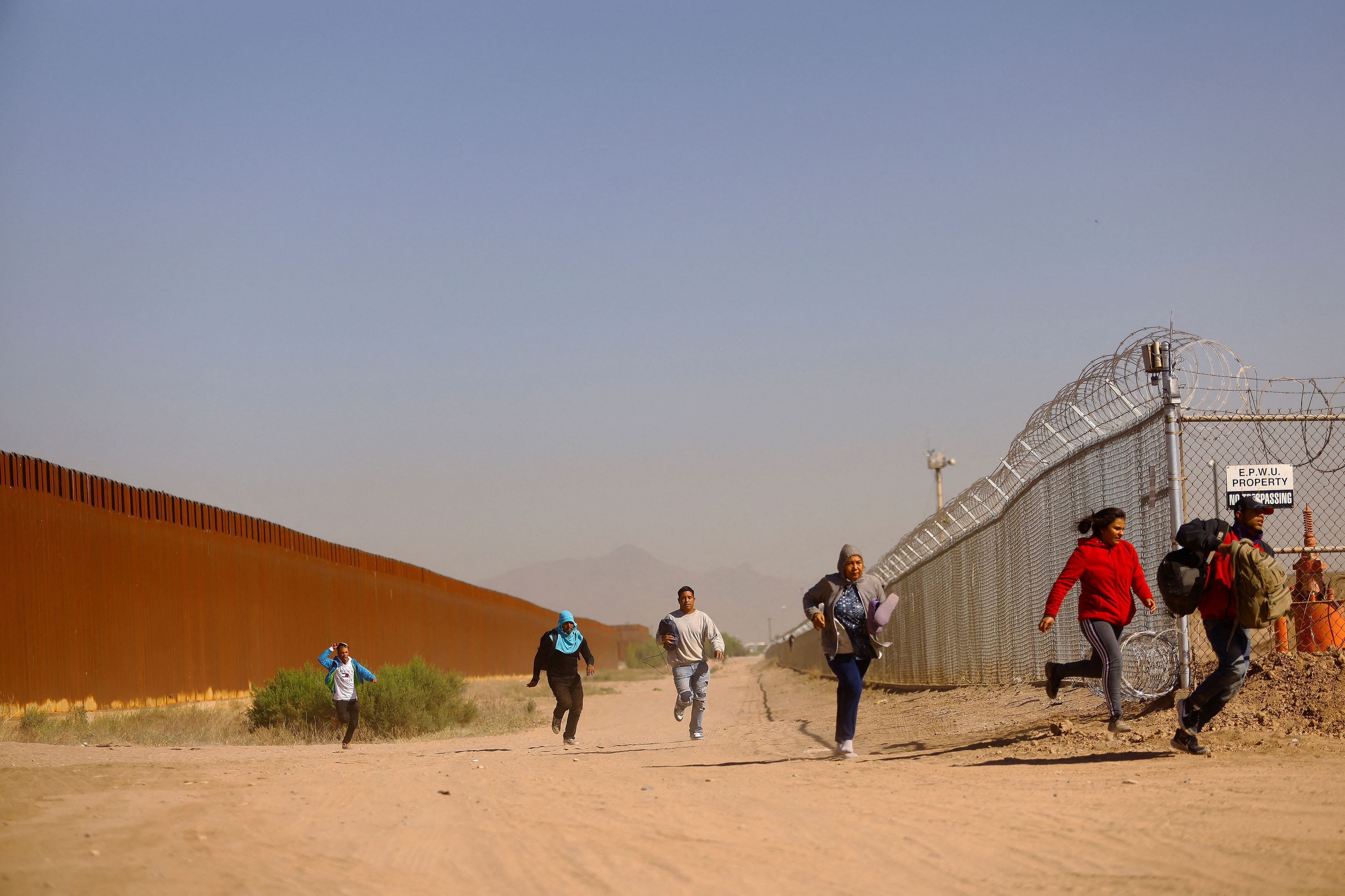 <div class="paragraphs"><p>Migrants run to hide from the U.S. Border Patrol and the Texas National Guard after crossing into the United States from Mexico, in El Paso, Texas, U.S., May 08, 2023. </p></div>