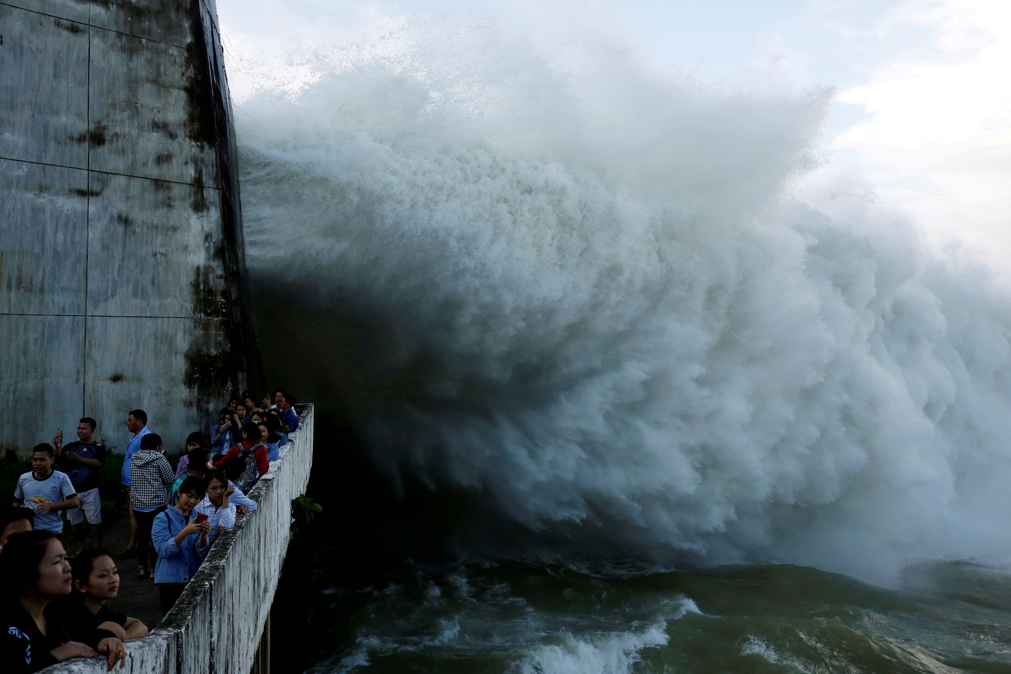 <div class="paragraphs"><p>FILE PHOTO: People watch as Hoa Binh hydroelectric power plant opens the flood gates after a heavy rainfall caused by a tropical depression in Hoa Binh province, outside Hanoi, Vietnam October 12, 2017. REUTERS/Kham/File P</p></div>