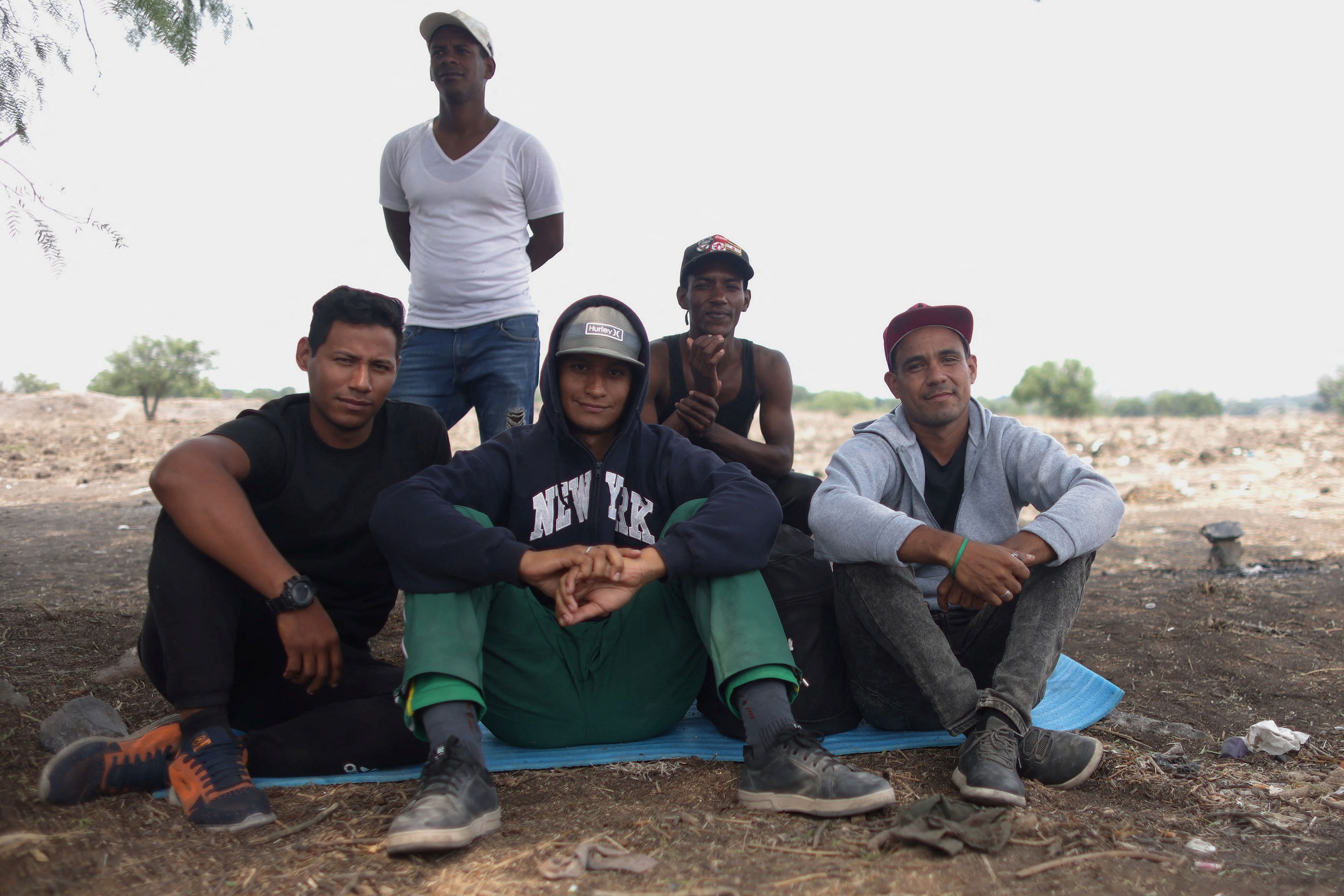 <div class="paragraphs"><p>Allender Ruy , poses for a picture with friends while waiting for a train in the site known as El Basurero, a stretch of land next to a trash dump and the railroad, as they continue their journey to the U.S.</p></div>