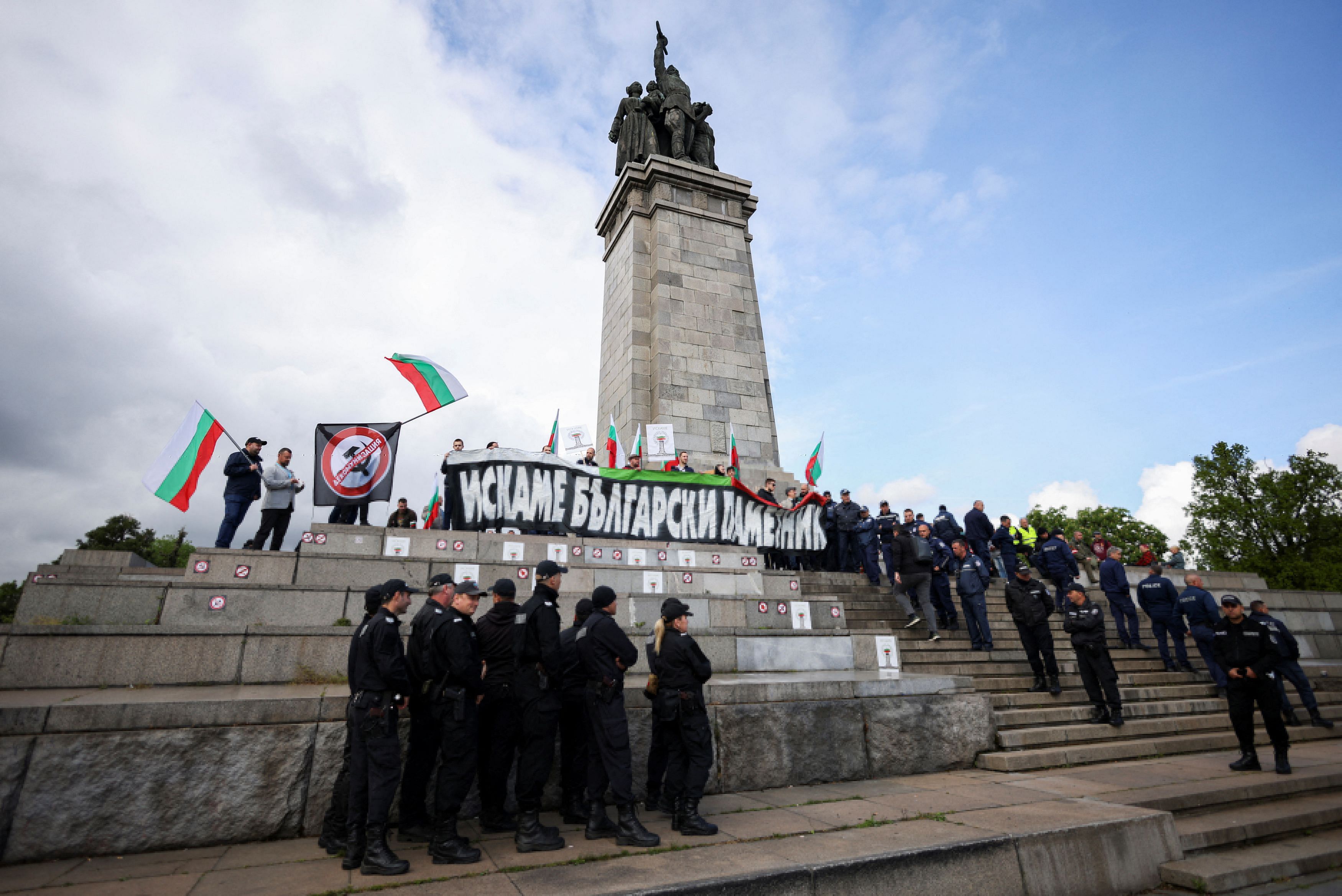 Anti-Russia protesters attend the Victory Day celebrations, which marks the anniversary of the victory over Nazi Germany in World War Two, in Sofia, Bulgaria, May 9, 2023. The text on the poster reads "We want a Bulgarian monument". REUTERS/Spasiyana Sergieva