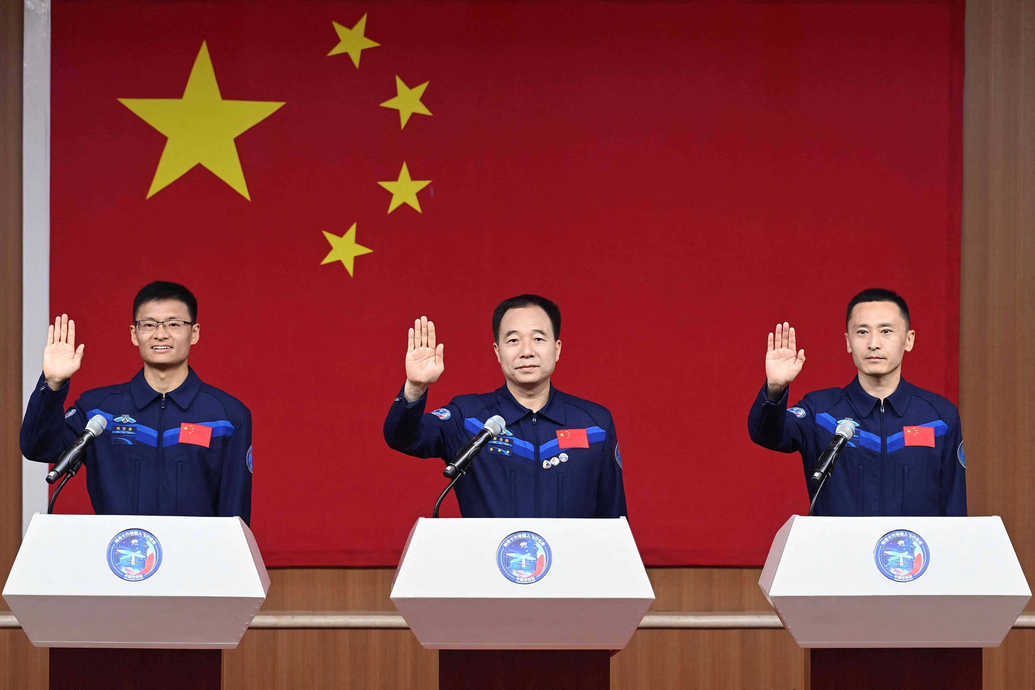 Astronauts Jing Haipeng, Zhu Yangzhu and Gui Haichao attend a press conference before the Shenzhou-16 spaceflight mission to China's space station, at Jiuquan Satellite Launch Center, near Jiuquan, Gansu province, China May 29, 2023. China Daily via REUTERS  ATTENTION EDITORS - THIS IMAGE WAS PROVIDED BY A THIRD PARTY. CHINA OUT.