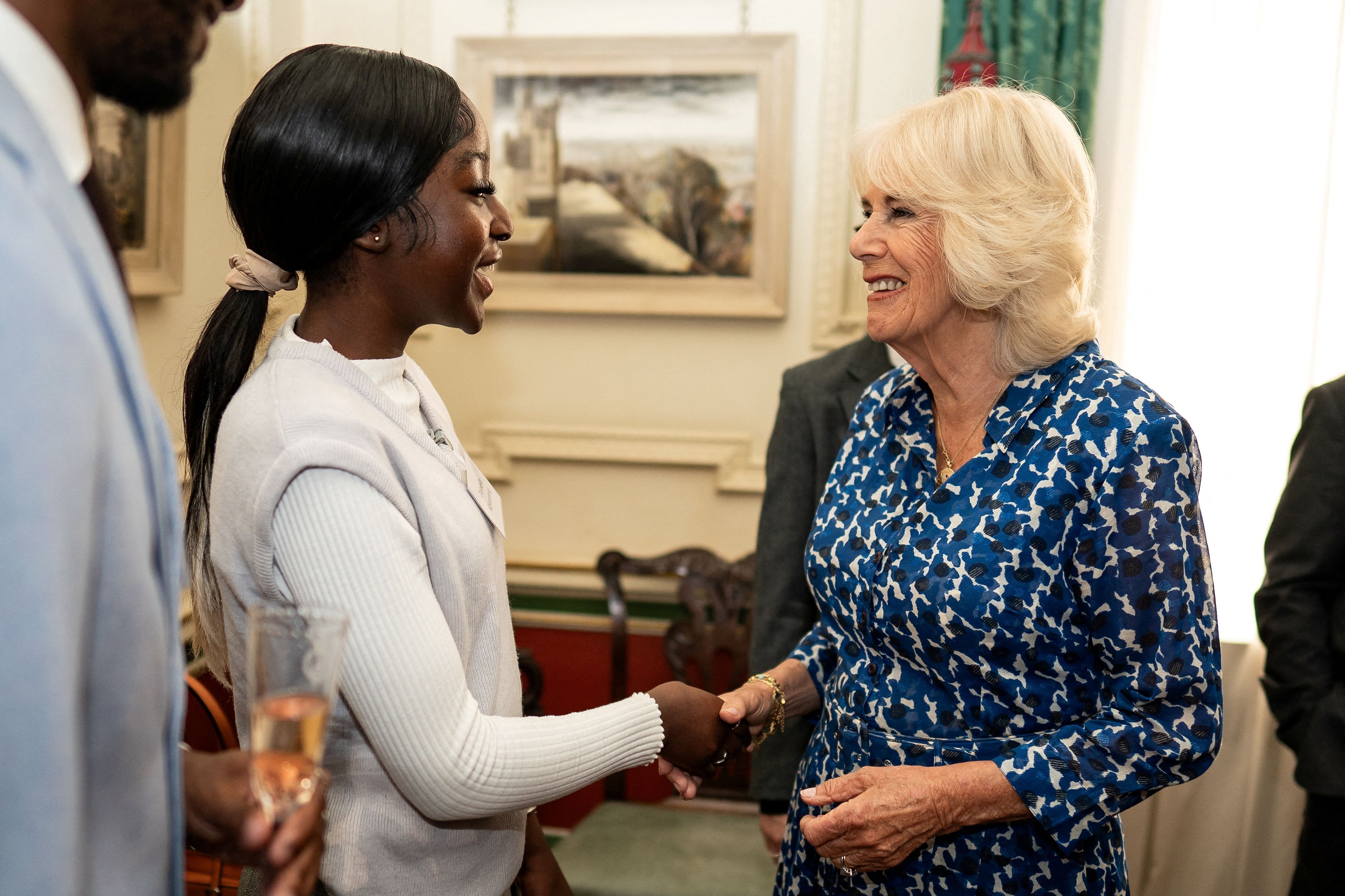 Queen Camilla greets guest Daniella Koranteng during a reception at Clarence House to celebrate the 15th anniversary of the First Story charity in London, Britain, July 11, 2023. Aaron Chown/Pool via REUTERS