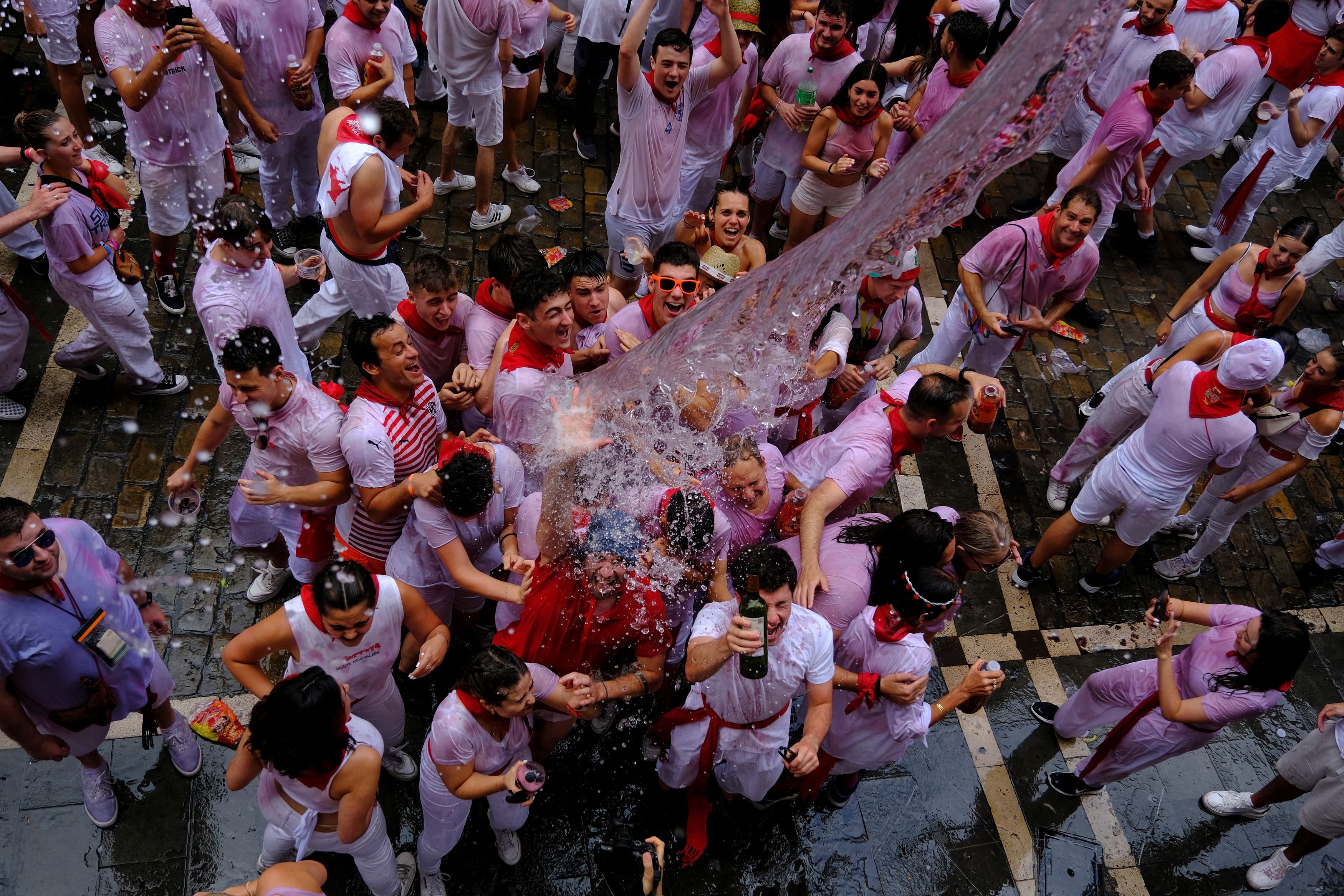 <div class="paragraphs"><p>Revellers are showered in water from the balcony of Cheryl Mountcastle, 69, who has been attending Sanfermines from the U.S. for the past 24 years, after the opening of Sanfermines in Pamplona, Spain, July 6, 2023. </p></div>
