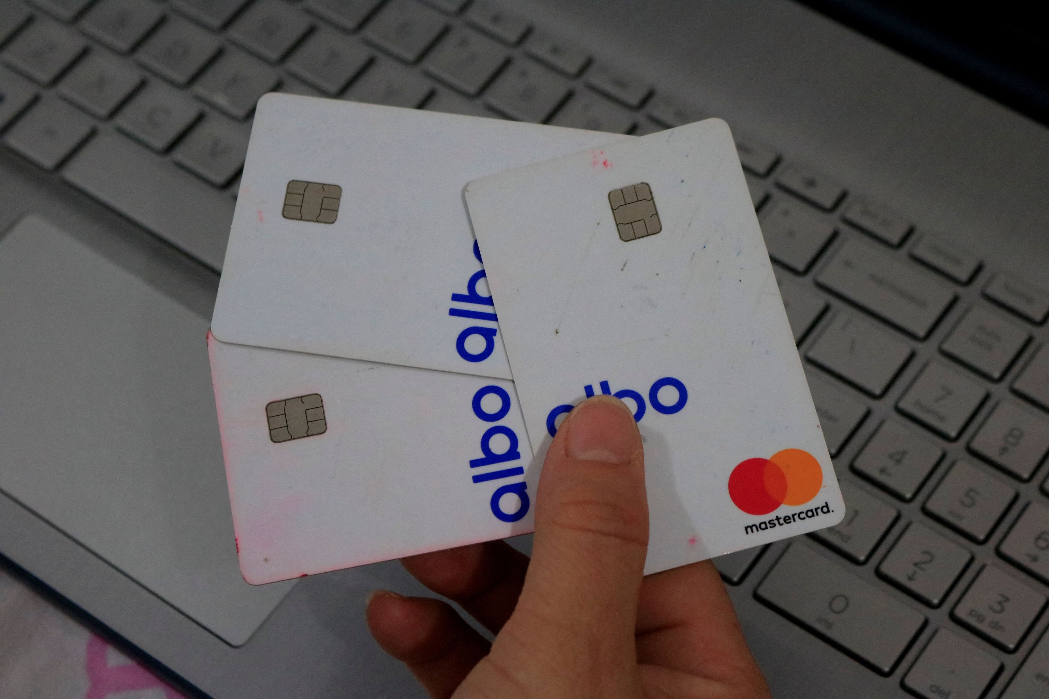 A woman, who doesn't want to be identified, shows Albo cards, a Mexican fintech, or mobile payments company, in Culiacan, in Sinaloa state, Mexico July 10, 2023. Albo didn't respond to Reuters requests for comment for this story. To match Special Report MEXICO-DRUGS/REMITTANCES REUTERS/Stringer