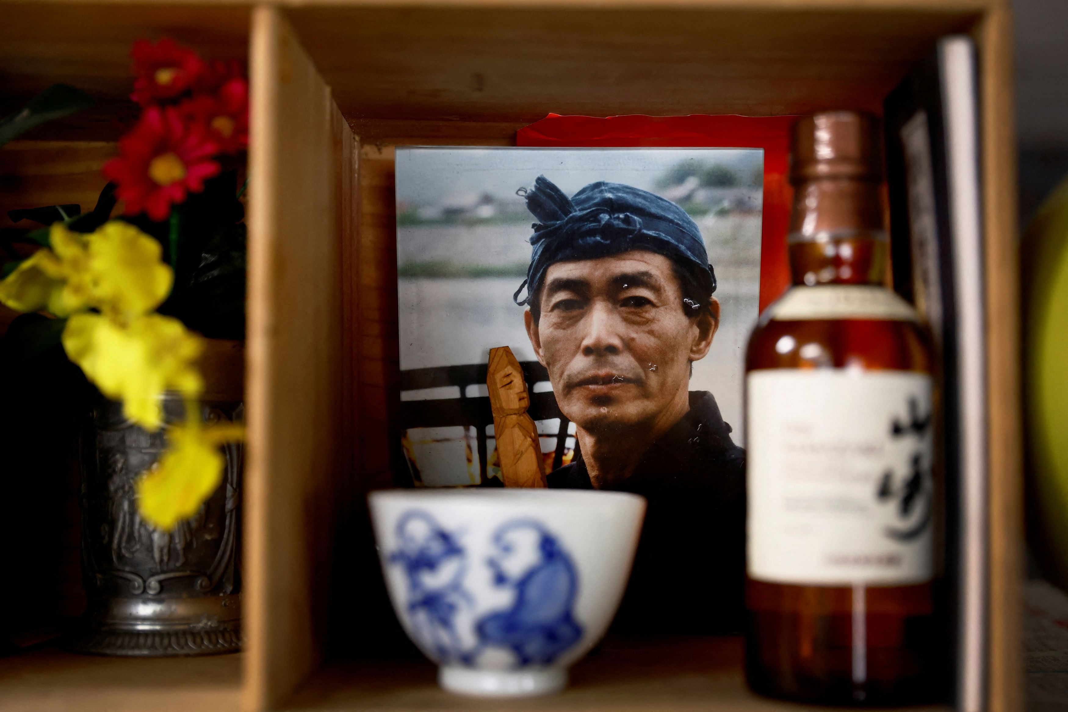 <div class="paragraphs"><p>A photo of a cormorant fishing master or usho Mikio, who passed away 17 years ago, stands on a small altar in his son's kitchen, usho Youichiro Adachi, 48.</p></div>