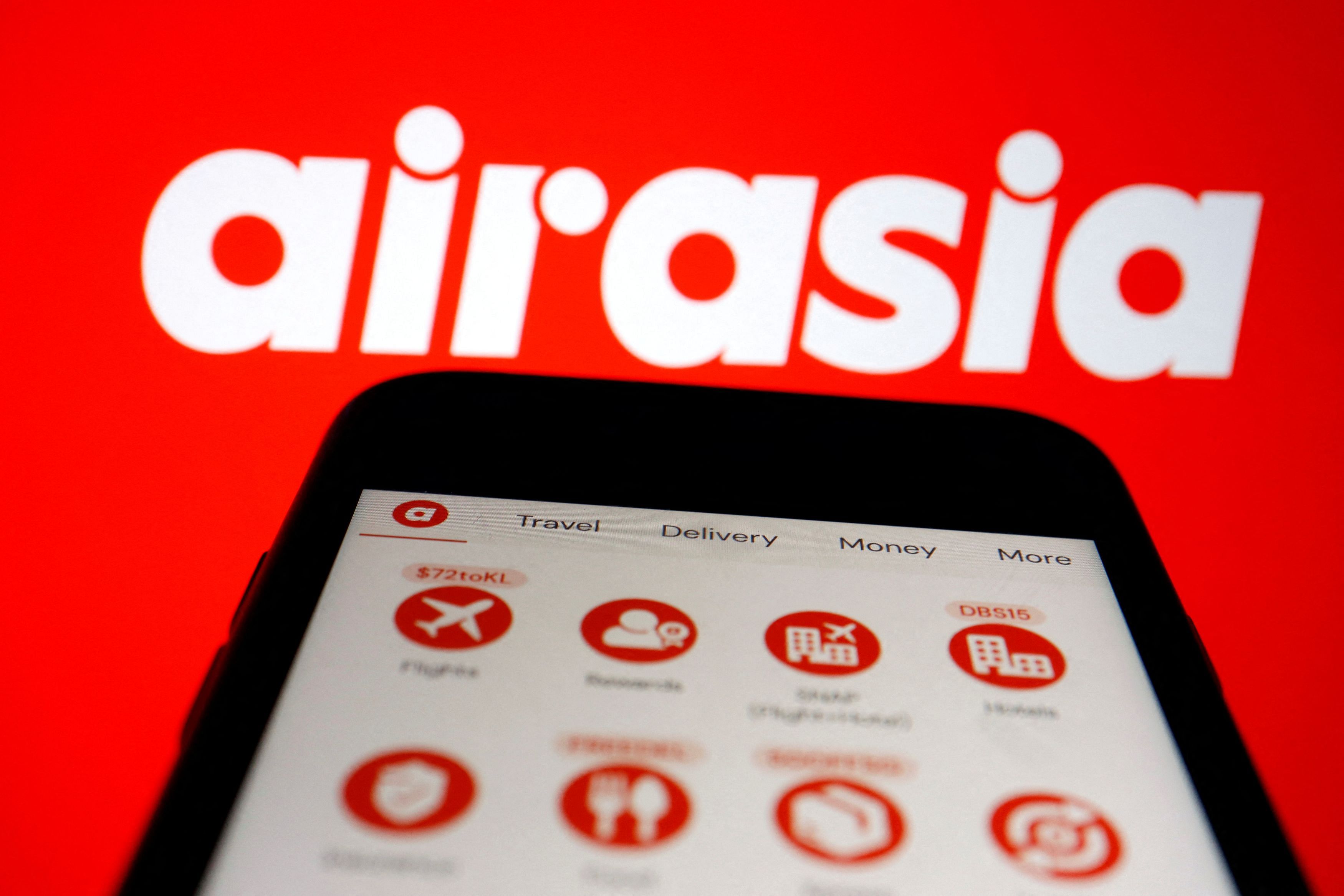 FILE PHOTO: The logo of AirAsia and airasia Super App under Capital A are seen displayed in this illustration picture taken March 7, 2022. REUTERS/Florence Lo/Illustration/File Photo