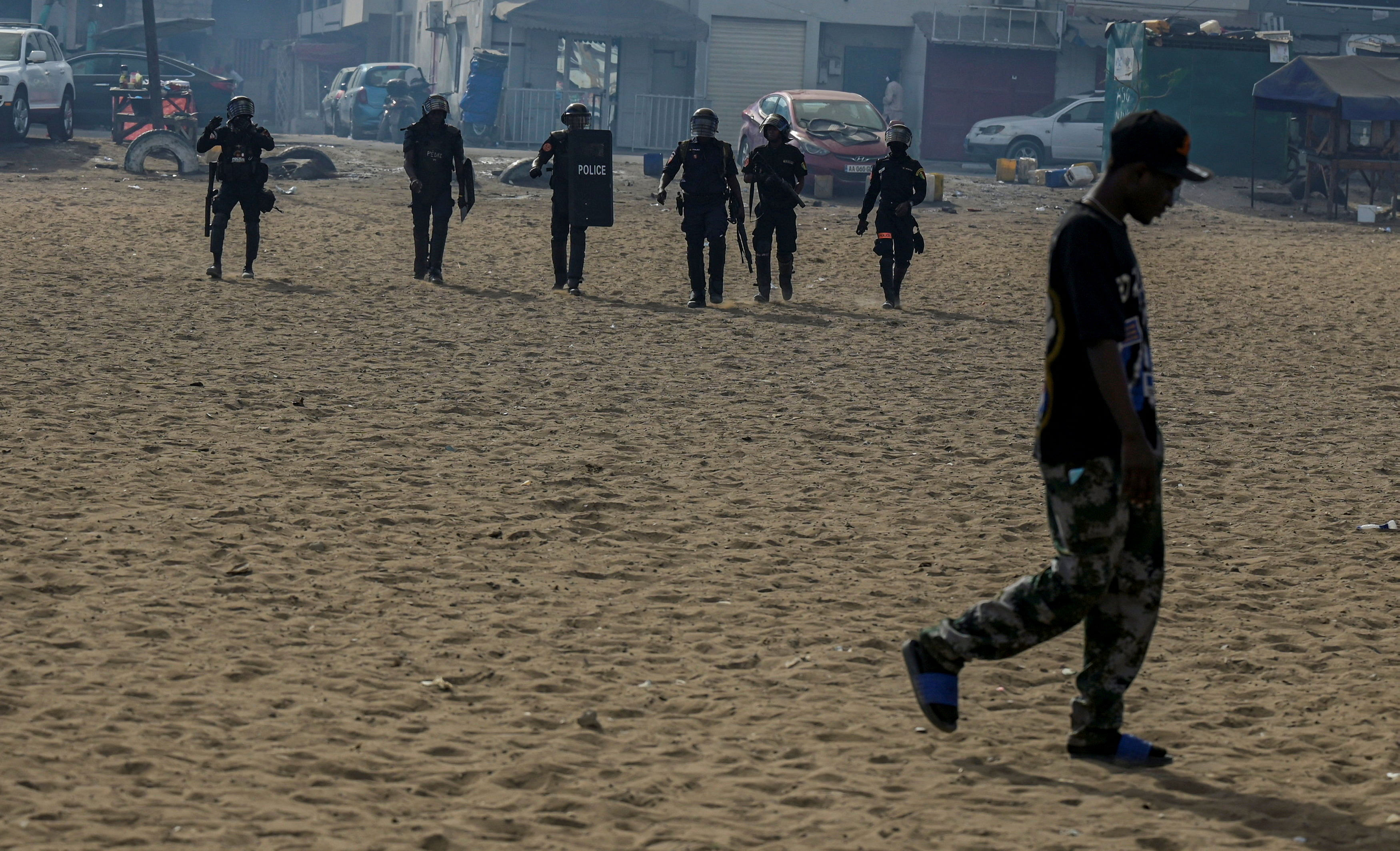 Riot police officers walk after dispersing a small protest against the postponement of the Feb. 25 presidential election, in Parcelle, district of Dakar, Senegal February 16, 2024. REUTERS/Zohra Bensemra