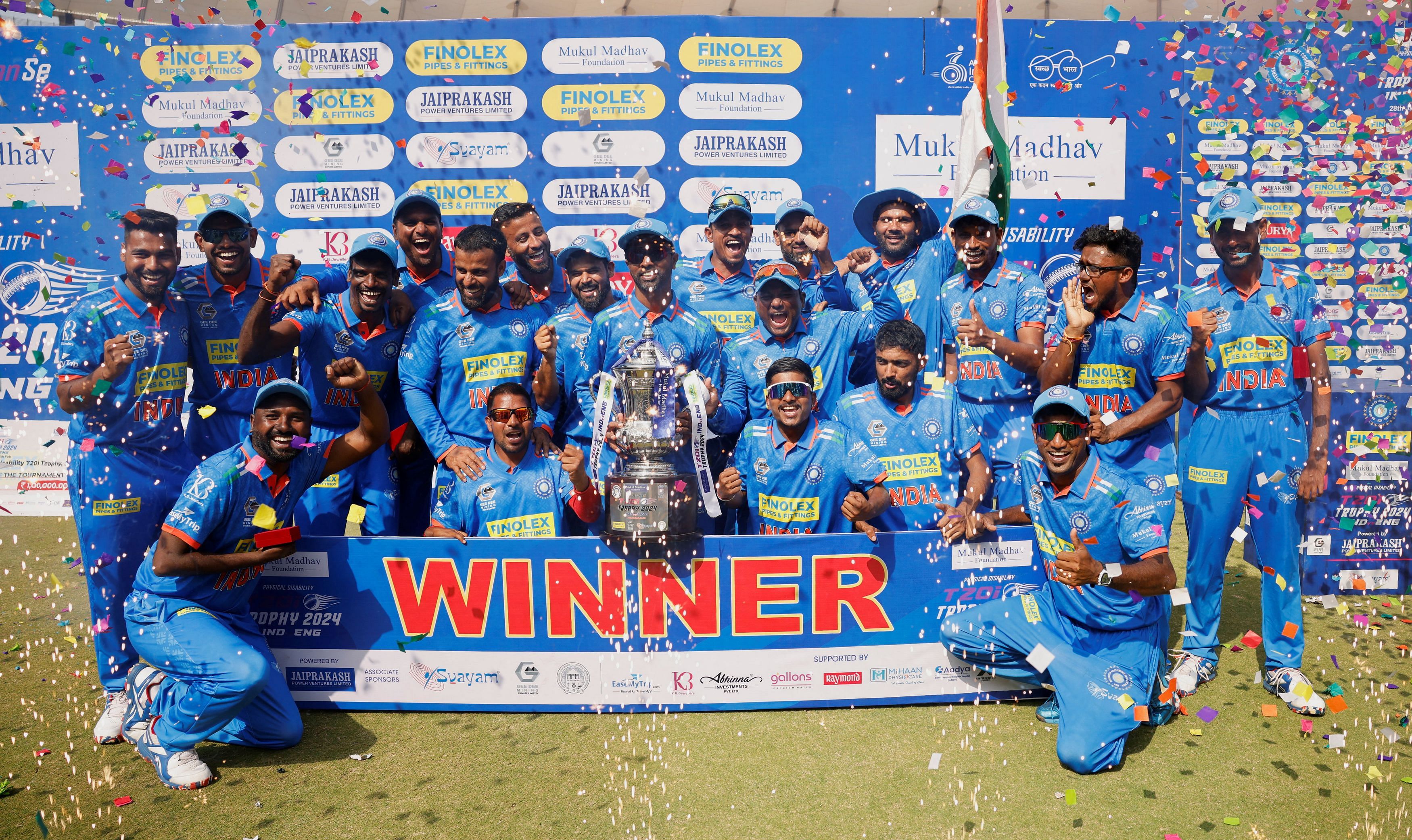 Indian physical disability cricket team players celebrate with a trophy after winning a T20 series against England at Narendra Modi Stadium in Ahmedabad, India, February 6, 2024.REUTERS/Amit Dave