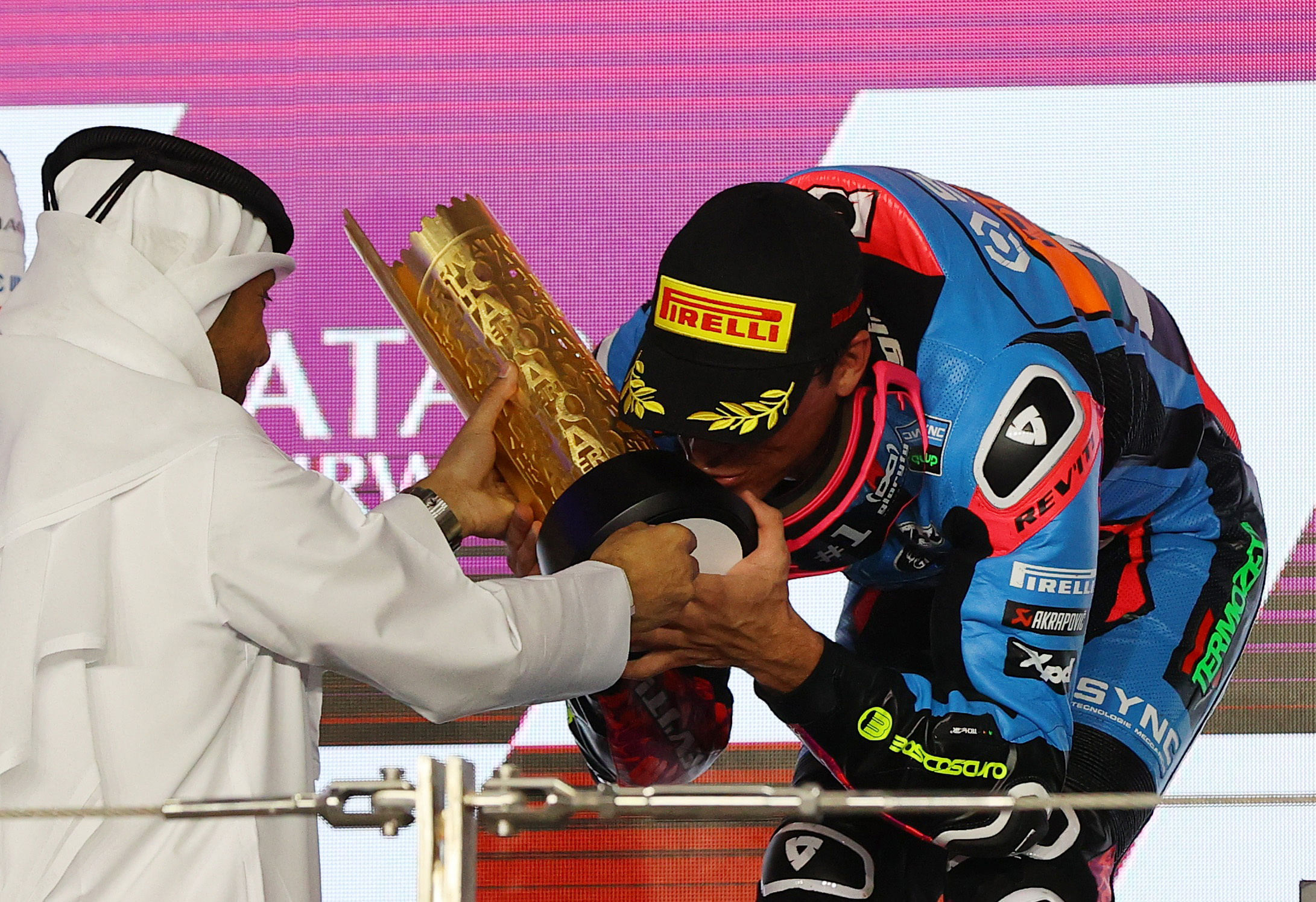 MotoGP - Grand Prix of Qatar - Lusail International Circuit, Lusail, Qatar - March 10, 2024 Sync SpeedUp's Alonso Lopez celebrates on the podium kissing a trophy after winning the Moto2 race REUTERS/Ibraheem Al Omari