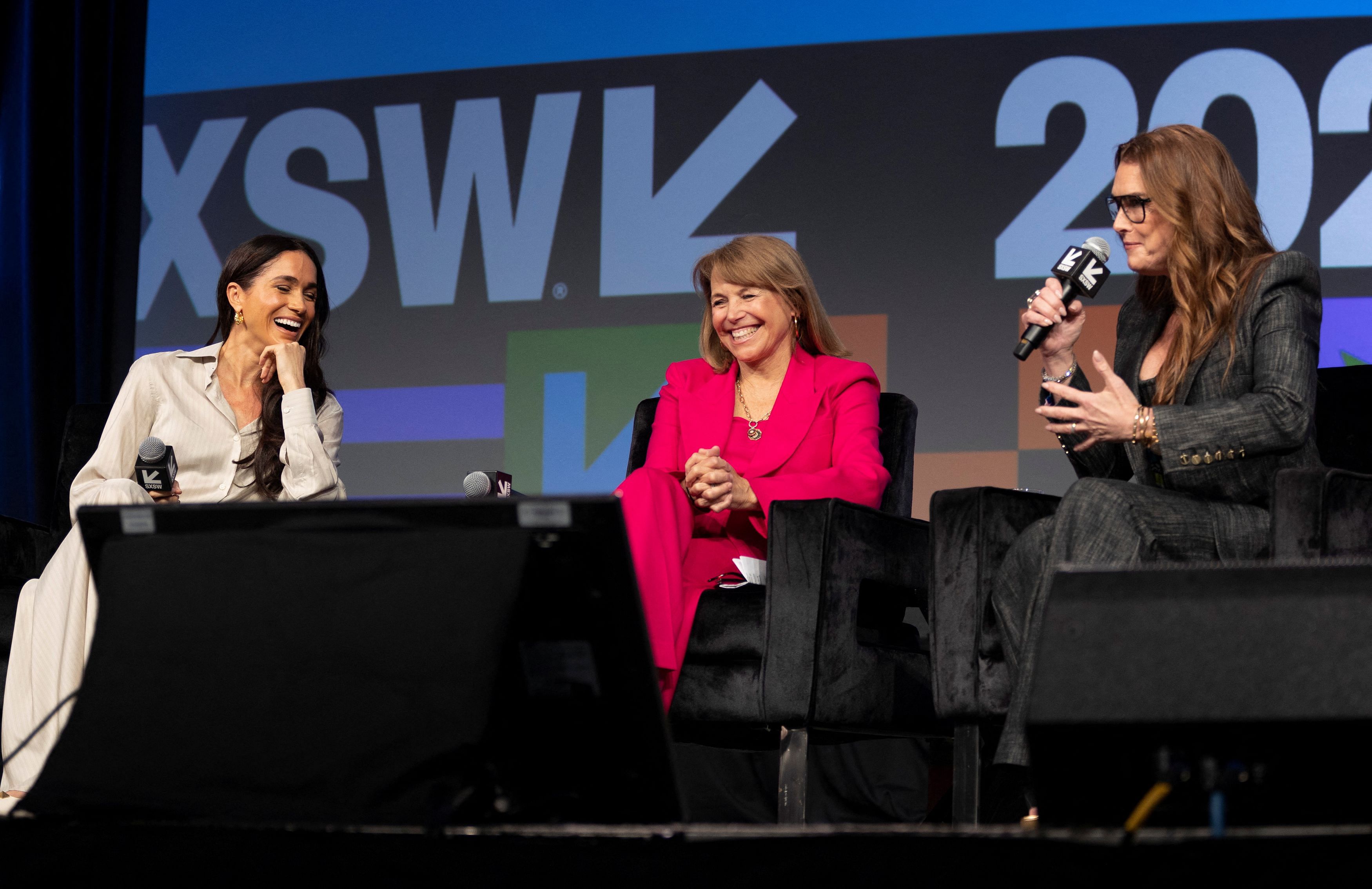 Meghan, Duchess of Sussex, left, and Katie Couric react as Brooke Shields, right, tells a story during a keynote on women’s representation in media and entertainment with Errin Haines and Nancy Wang Yuen at the South by Southwest Conference  in Austin,Texas, U.S. March 8, 2024.  REUTERS/Nuri Vallbona