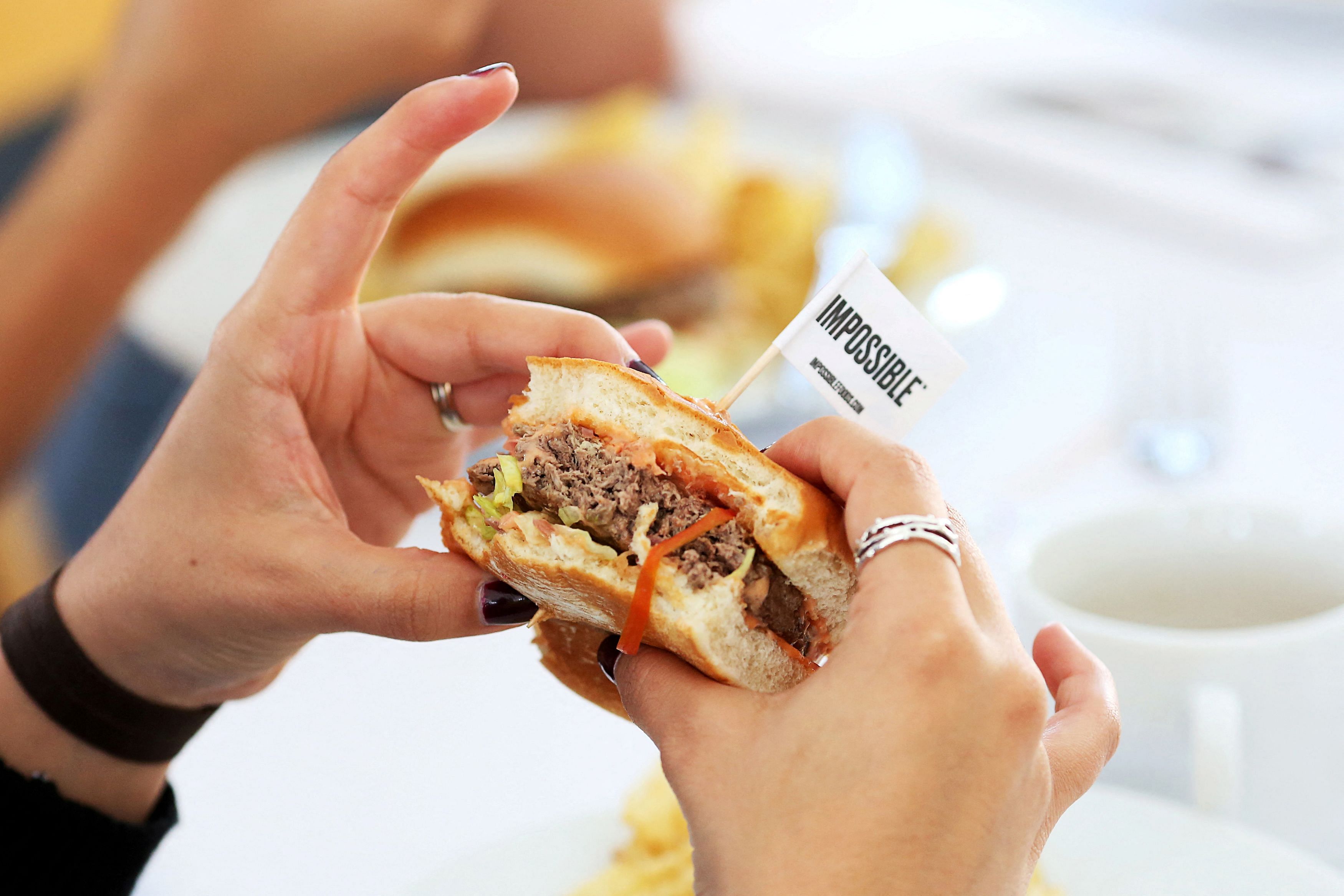 FILE PHOTO: Journalists taste test the plant based hamburgers during a media tour of Impossible Foods labs and processing plant in Redwood City, California, U.S. October 6, 2016. Picture taken October 6, 2016.  REUTERS/Beck Diefenbach/File Photo