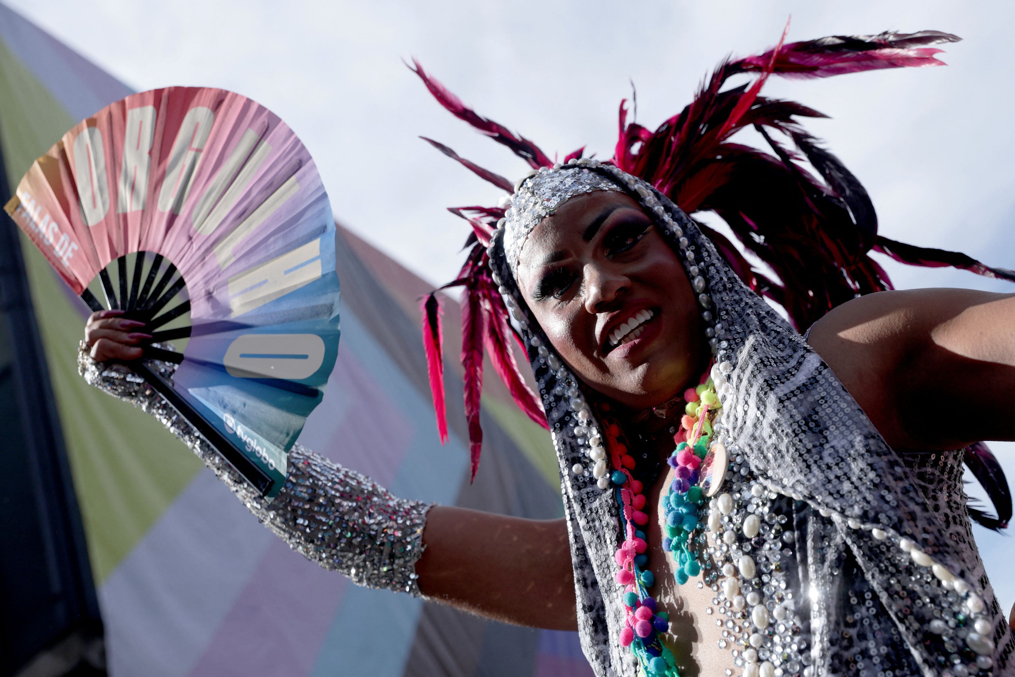 A drag queen holds a hand fan with text reading "Pride" during a march through Paulista Avenue to celebrate LGBTQ+ rights during the annual Pride parade, in Sao Paulo, Brazil June 2, 2024. REUTERS/Carla Carniel