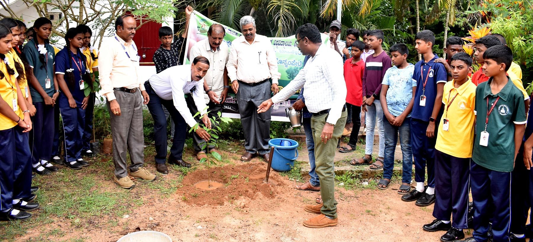 ಗೋಣಿಕೊಪ್ಪಲು ಅನುದಾನಿತ ಪ್ರೌಢಶಾಲೆಯಲ್ಲಿ ಬುಧವಾರ ನಡೆದ ಪರಿಸರ ದಿನಾಚರಣೆಯಲ್ಲಿ ಪ್ರೊ.ದೇವಗಿರಿ ಗಿಡನೆಟ್ಟರು. ಪ್ರೊ.ಕೆಂಚರೆಡ್ಡಿ, ಕೃಷ್ಣ ಚೈತನ್ಯ ಹಾಜರಿದ್ದರು