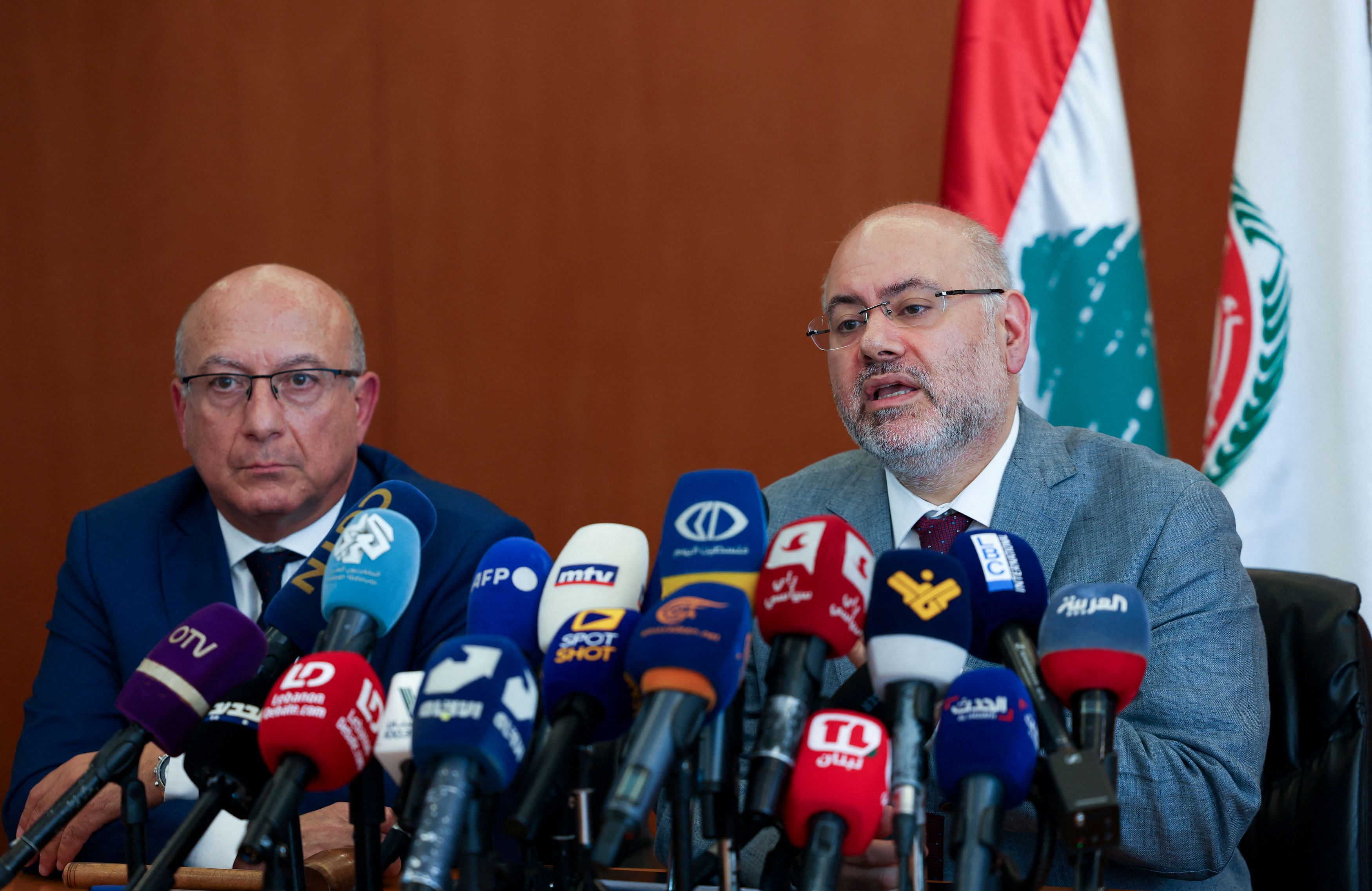 Lebanese caretaker Health Minister Firass Abiad sits next to the President of the Lebanese Doctors Syndicate, Youssef Bakhash, as he speaks during a press conference in Beirut, Lebanon September 20, 2024. REUTERS/Mohamed Azakir