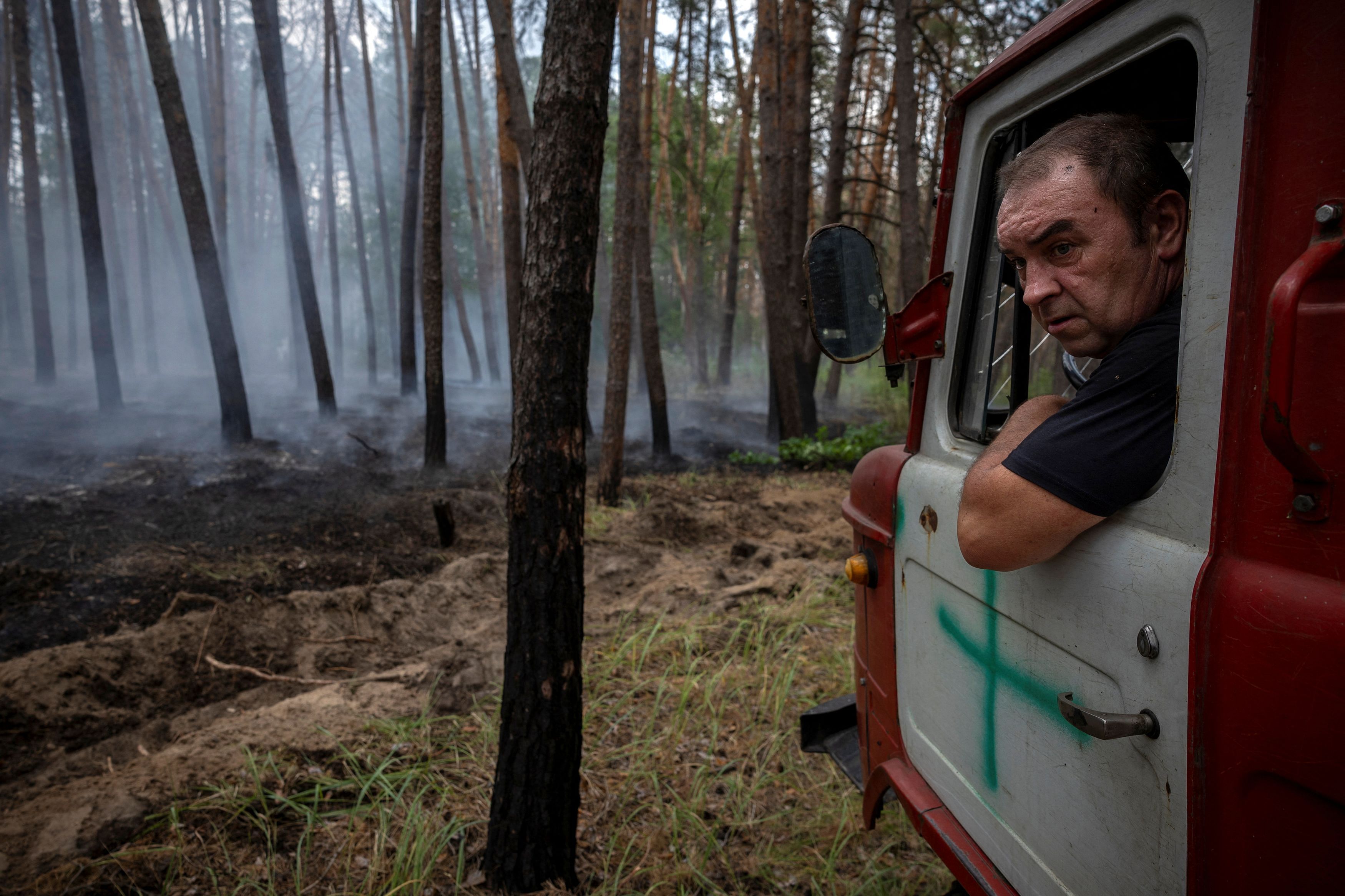 <div class="paragraphs"><p>A firefighter drives a fire engine during a forest fire near Yarova, Sviati Hory national park, Donetsk region.</p></div>