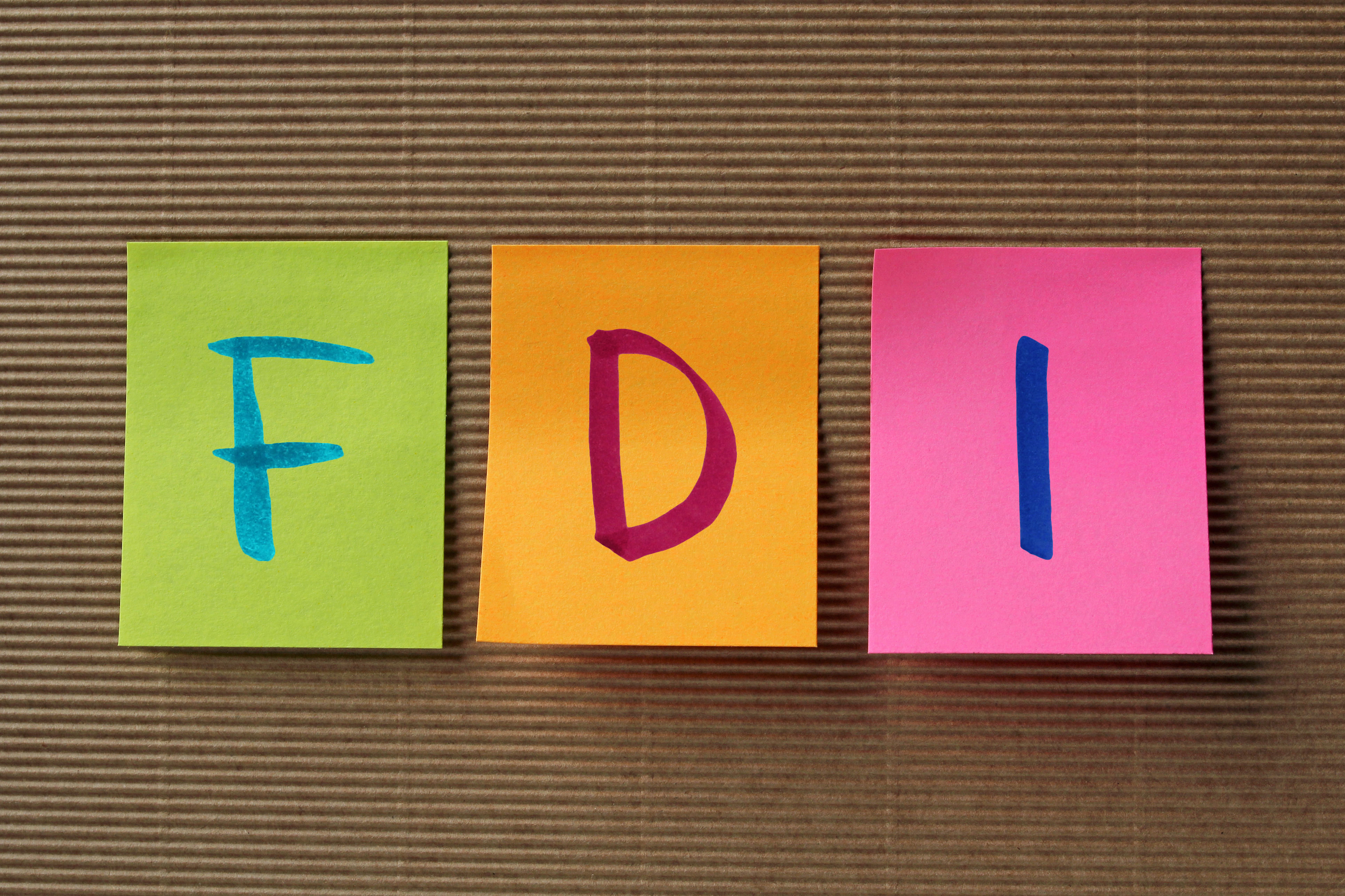 FDI (Foreign Direct Investment) acronym on colorful sticky notes
FDI