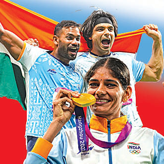 Hangzhou: India's Neeraj Chopra (R) and Kishore Kumar Jena wave the national flag after securing gold and silver medal respectively in the Men's Javelin Throw Final event at the 19th Asian Games, in Hangzhou, China, Wednesday, Oct. 4, 2023. (PTI Photo/Shailendra Bhojak) (PTI10_04_2023_000376A)