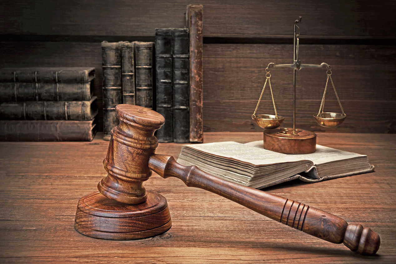 Closeup Of Judges Gavel, Legal Code, Scales Of Justice On The Rough Wooden Background. Law Concept