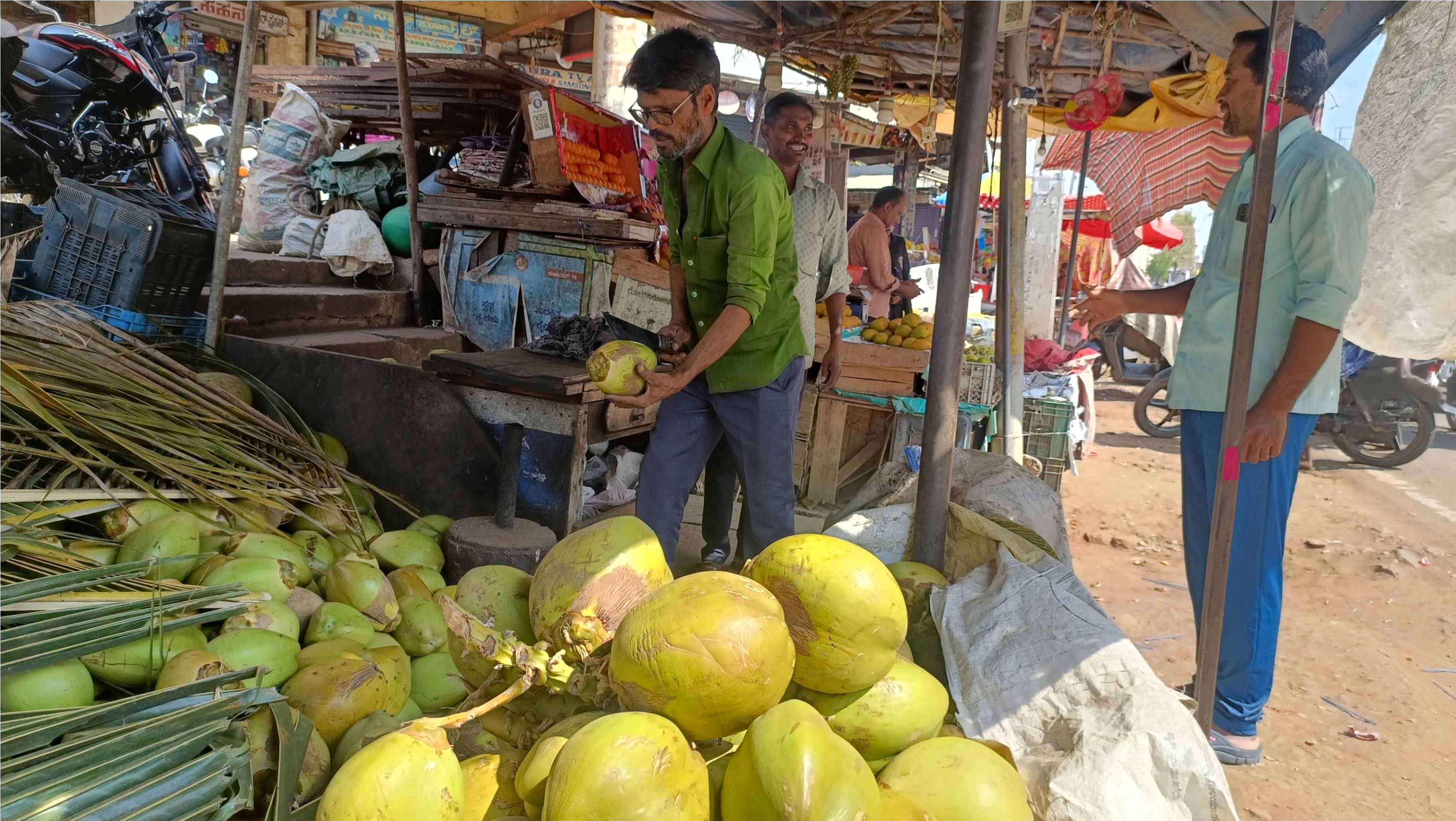 ಹರಿಹರದ ಗಾಂಧಿ ಸರ್ಕಲ್‌ನ ಎಳನೀರು ಅಂಗಡಿಯಲ್ಲಿ ದುಬಾರಿ ದರ ನೀಡಿ ಎಳನೀರು ಸೇವಿಸುತ್ತಿರುವ ಸಾರ್ವಜನಿಕರು