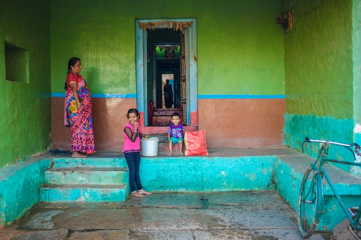 Kamalapuram, India - February 2, 2015: Indian family outside thier home in a town close to HampiRural India