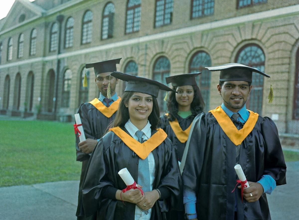 Team of multi-ethnic students in their graduation gowns.