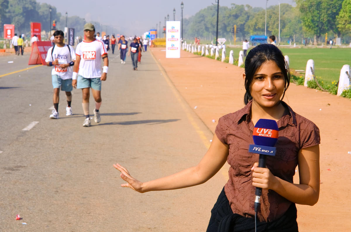 Delhi, India - October 28, 2007: Young female TV commentator reporting on marathon on October 28th, 2007 in Delhi, India.