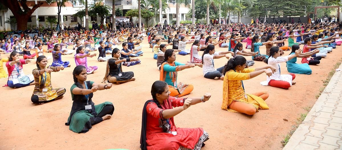 Yoga lovers, students of various Yoga centres participated in 5th World Yoga Day, Yoga for Heart programme organised by Health and Family welfare, AYSUH (Ayurveda, Yoga and Naturopathy, Unani, Siddha and Homoeopathy) Department in association with Karnataka State Olympic Association and various Yoga centers at Sree Kanteerava Stadium in Bengaluru on Friday. Photo by S K Dinesh
