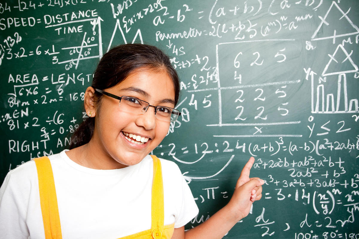 Cheerful Indian Girl Student with Mathematics Problems