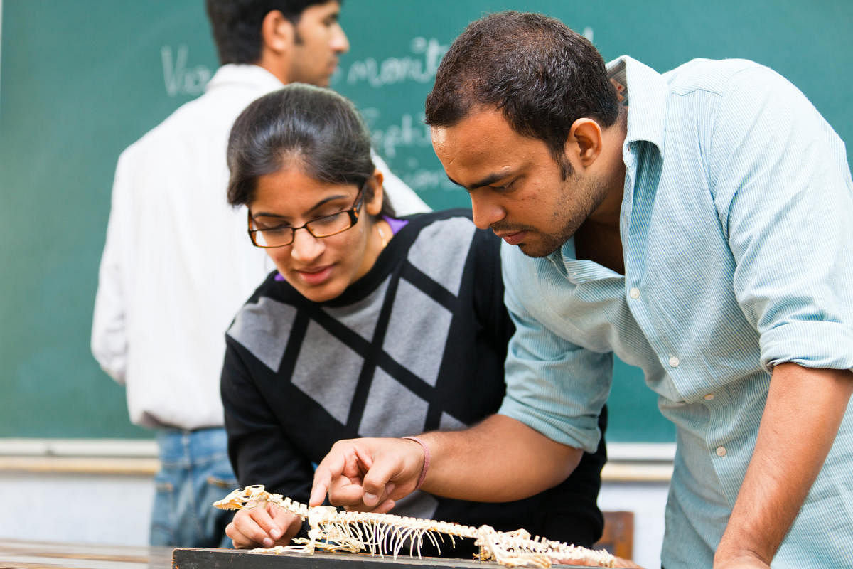 indian students with monitor lizard skeleton
